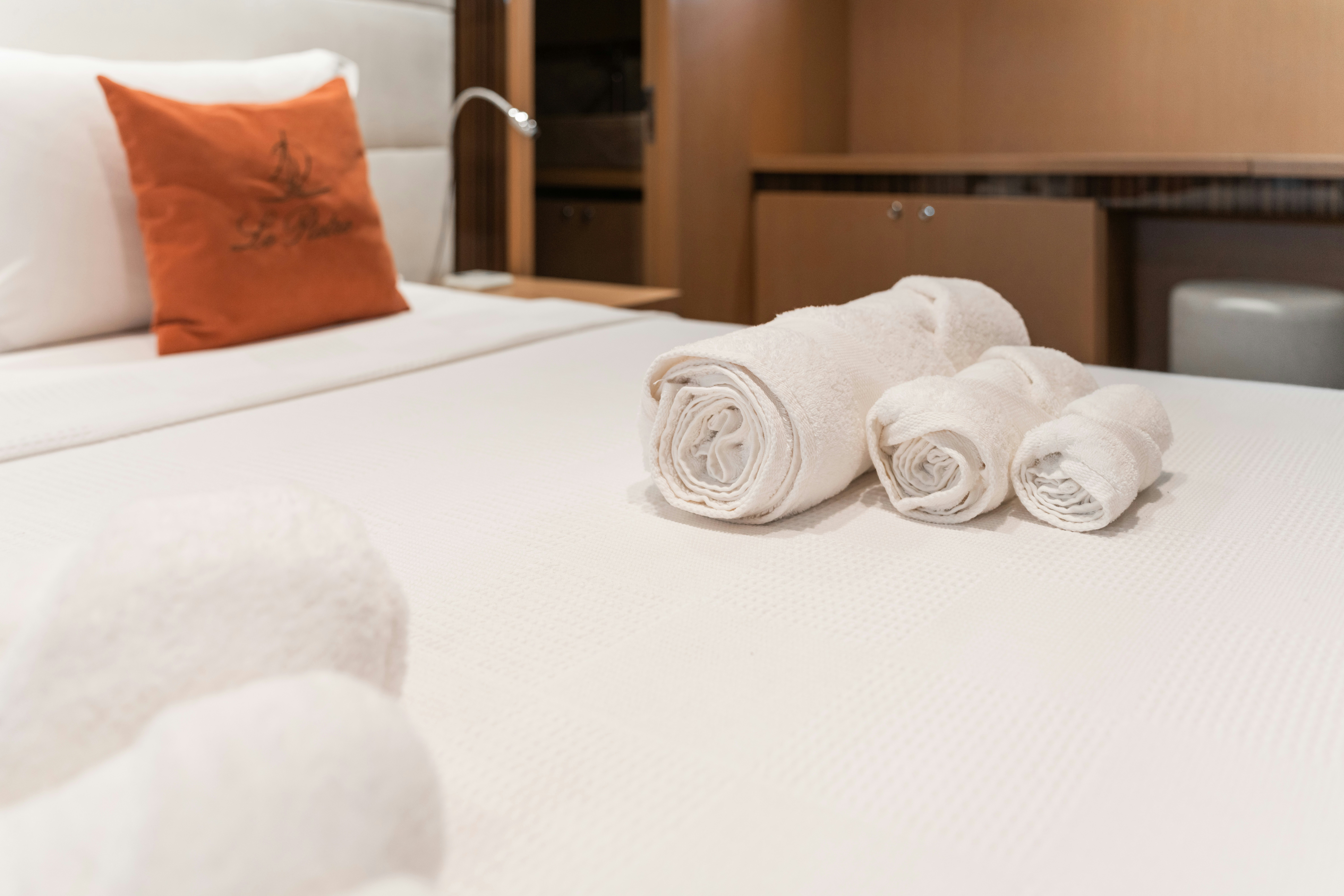 a bed with towels on it aboard LE PIETRE Yacht for Sale