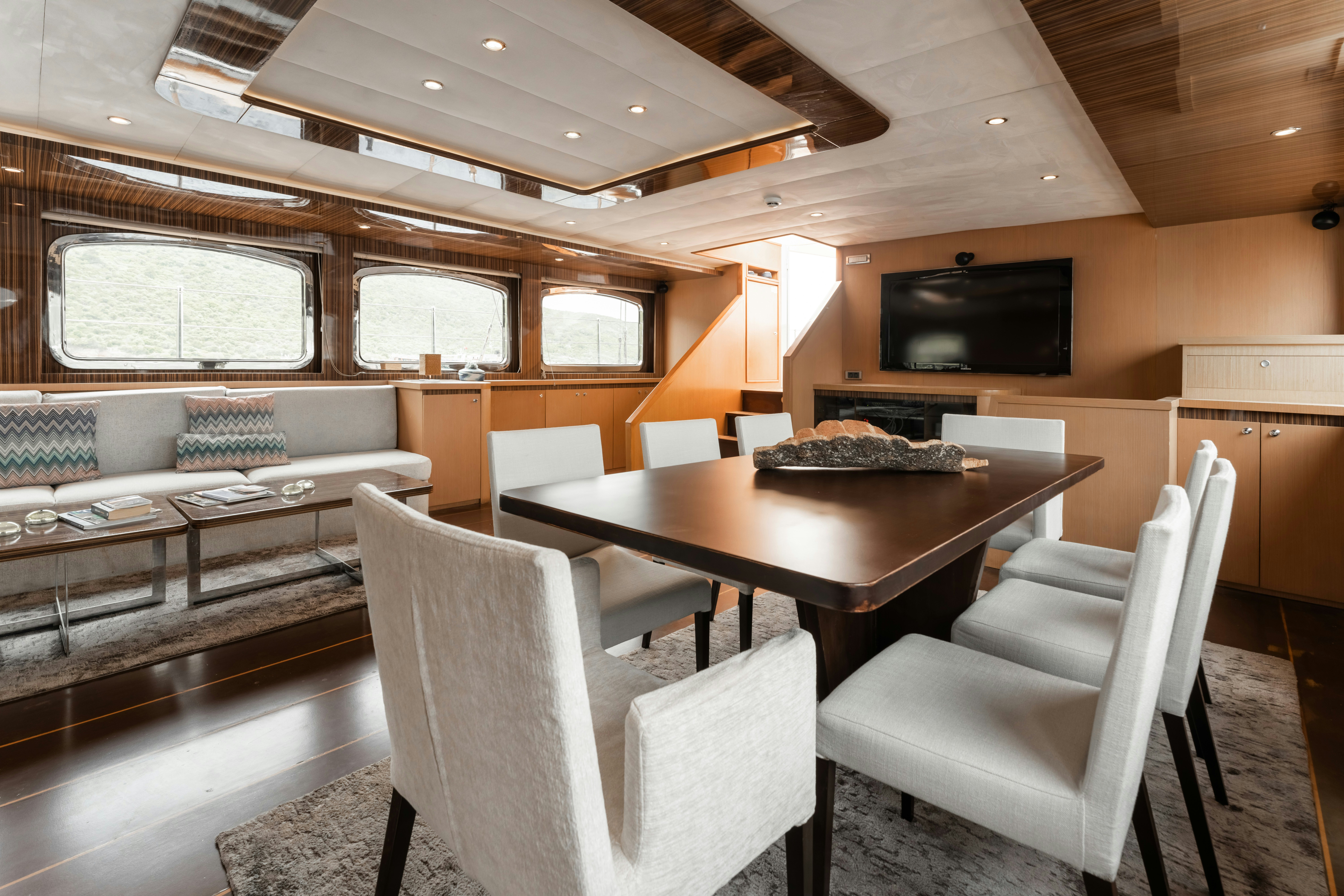 a room with a table and chairs aboard LE PIETRE Yacht for Sale