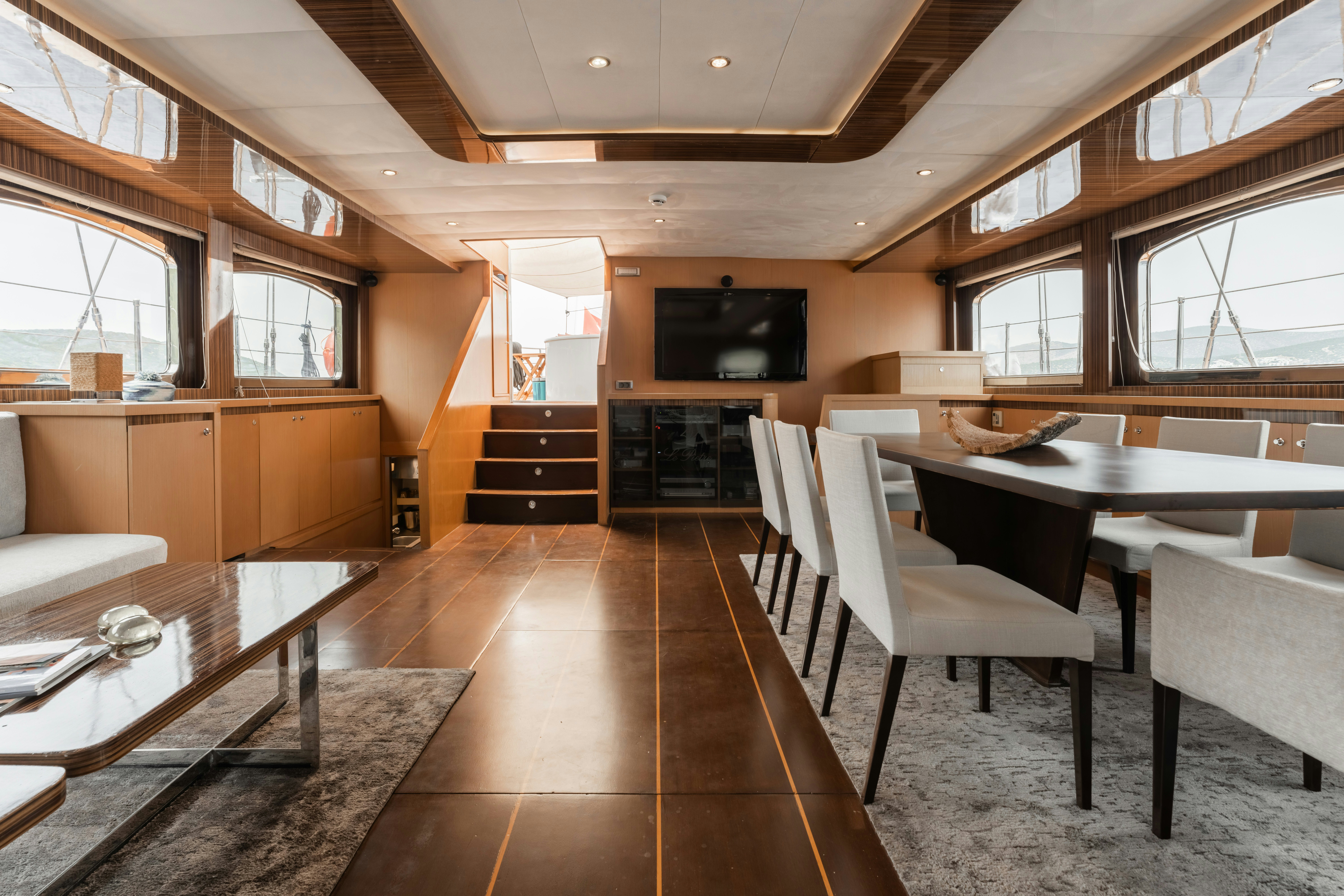 a room with a table and chairs aboard LE PIETRE Yacht for Sale