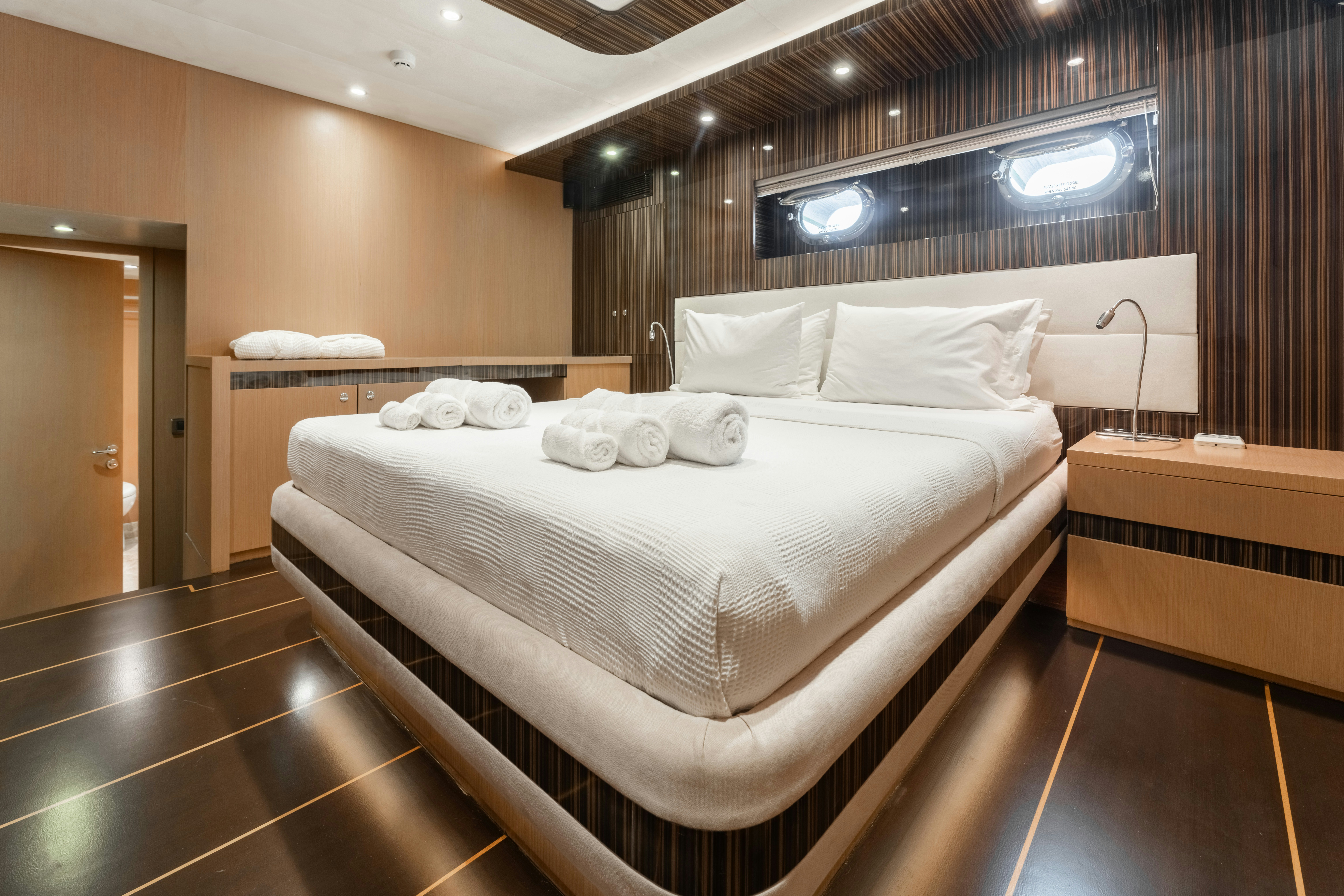 a room with a bed and a mirror aboard LE PIETRE Yacht for Sale