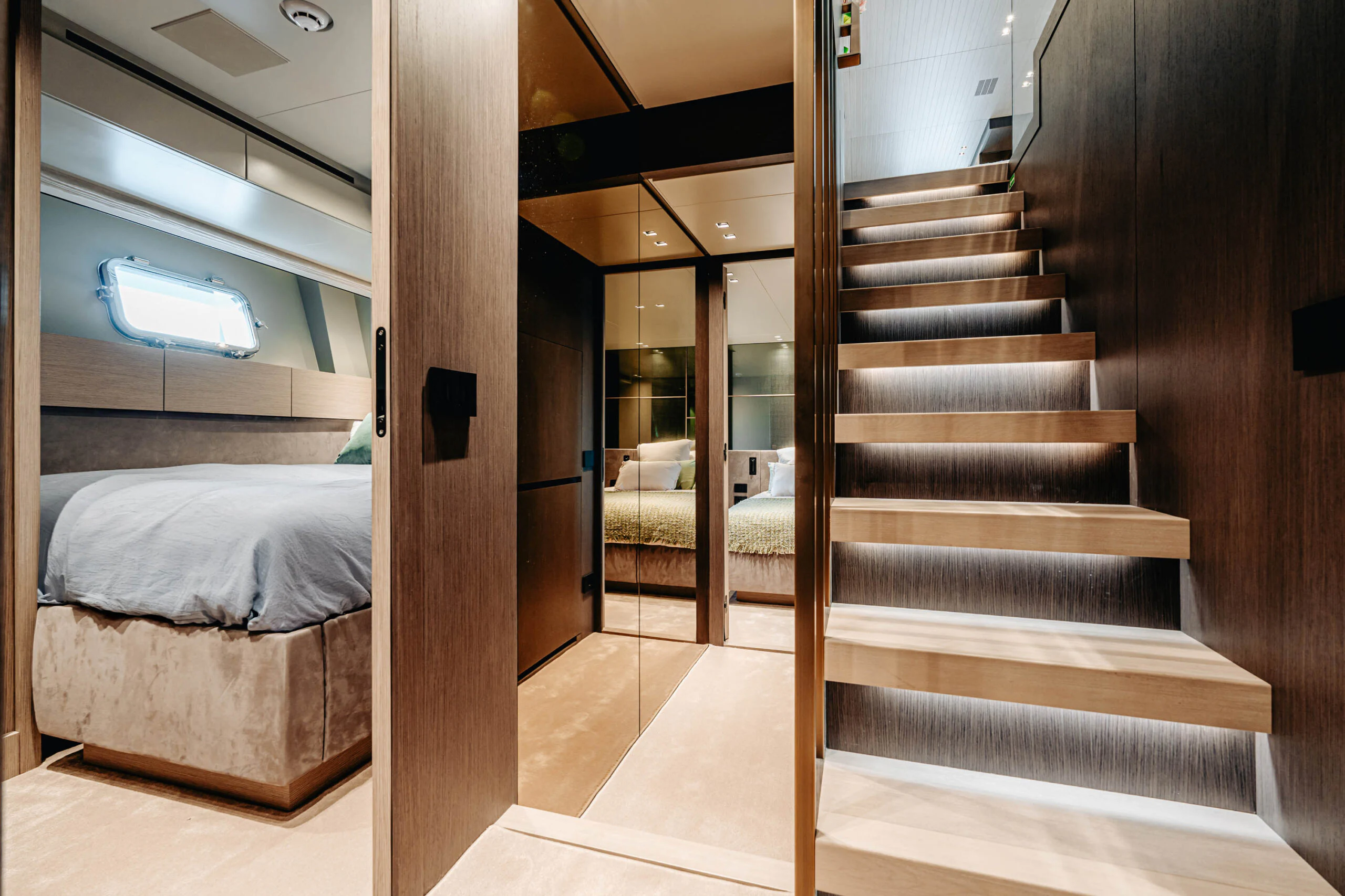 a room with a bed and a wood staircase aboard BLUE ZONE Yacht for Sale