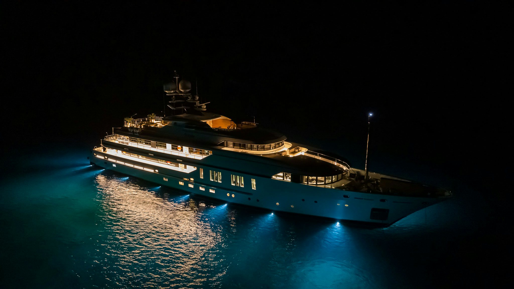 a large ship at night aboard SEALION Yacht for Charter