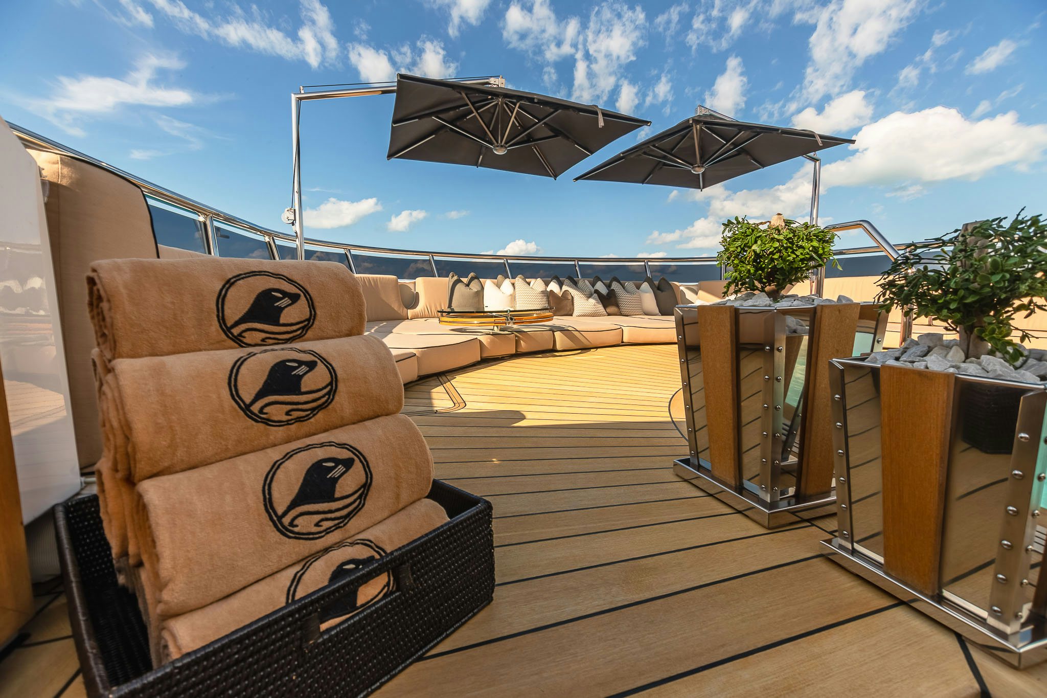 a deck with a wood deck and chairs and a large satellite dish on it aboard SEALION Yacht for Charter
