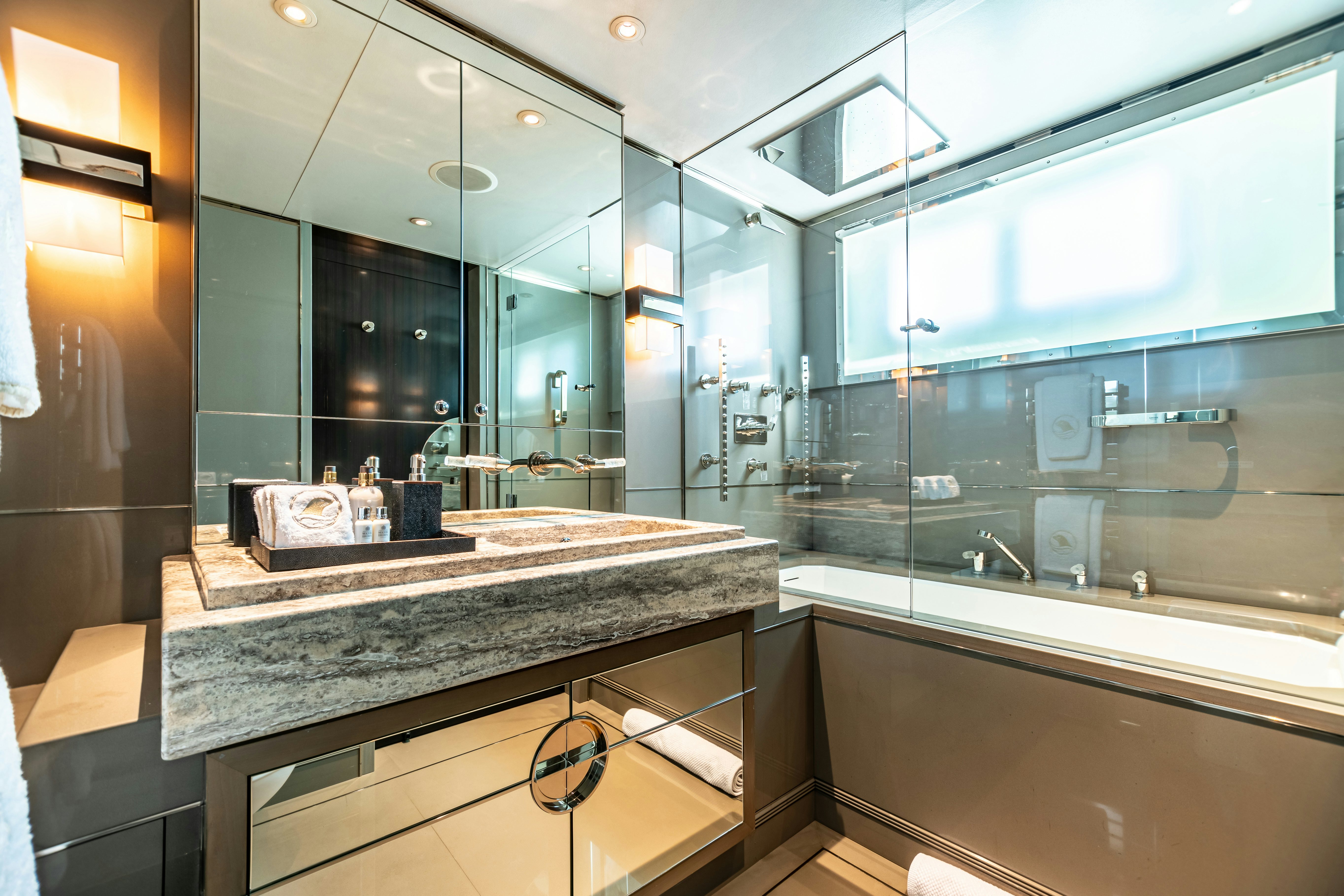 a bathroom with a large mirror aboard SEALION Yacht for Charter