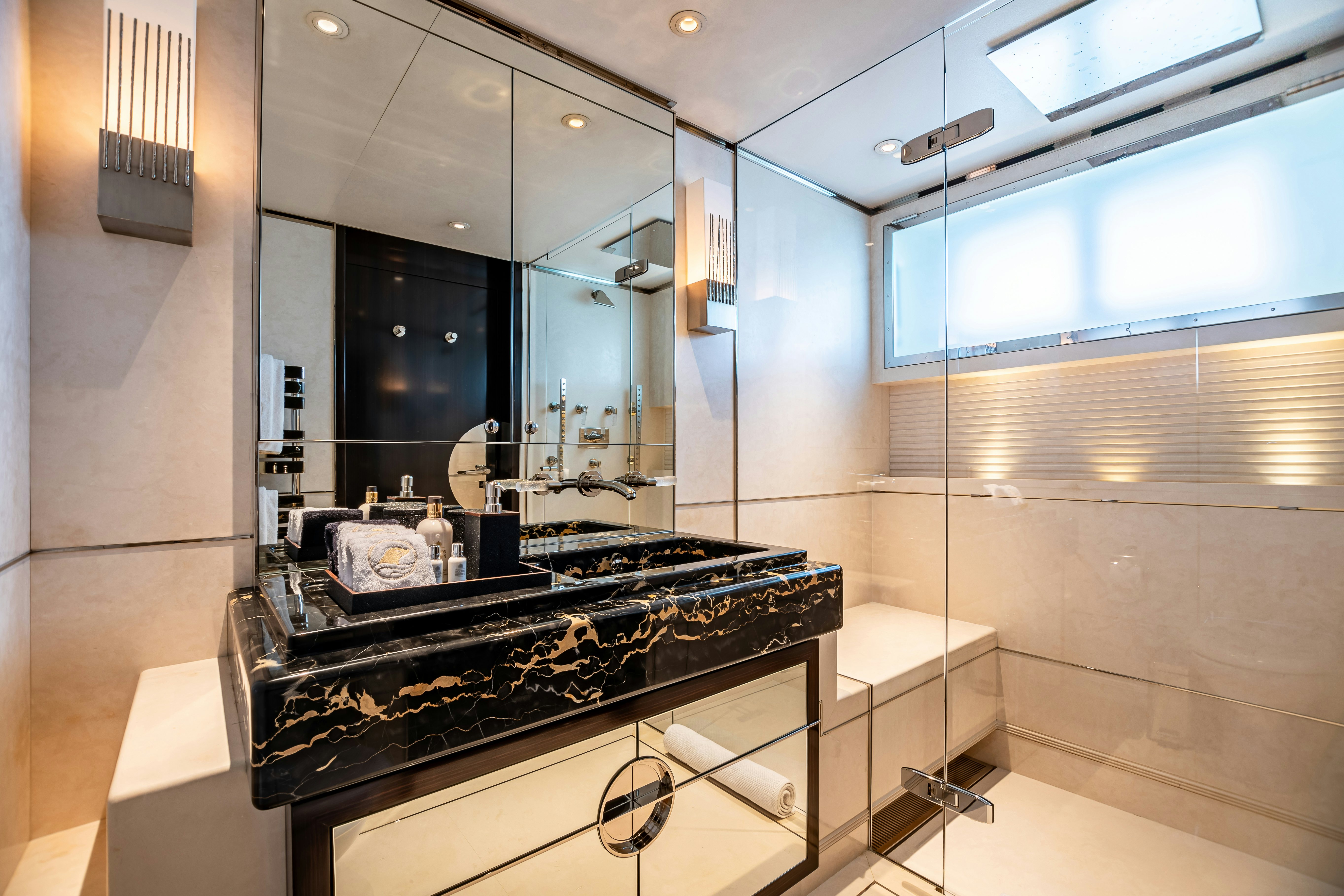 a bathroom with a large mirror aboard SEALION Yacht for Charter