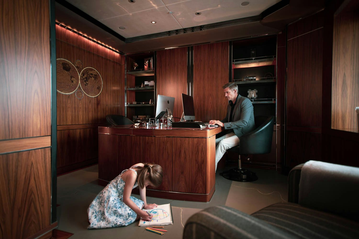 a man and a woman sitting at a table in a room aboard SEALION Yacht for Charter