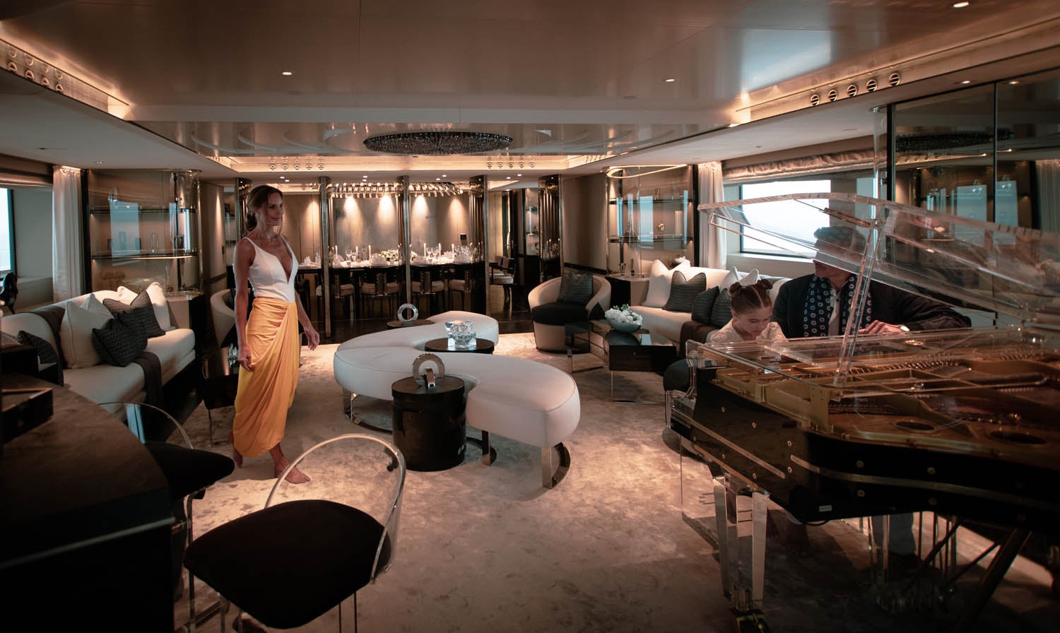 a woman and a man in a room with a table and chairs aboard SEALION Yacht for Charter
