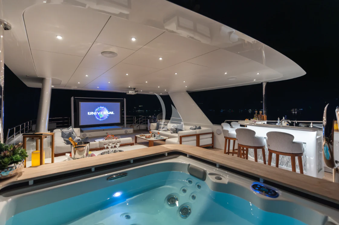 a large room with a large pool table and chairs aboard LIMITED RISKS Yacht for Charter