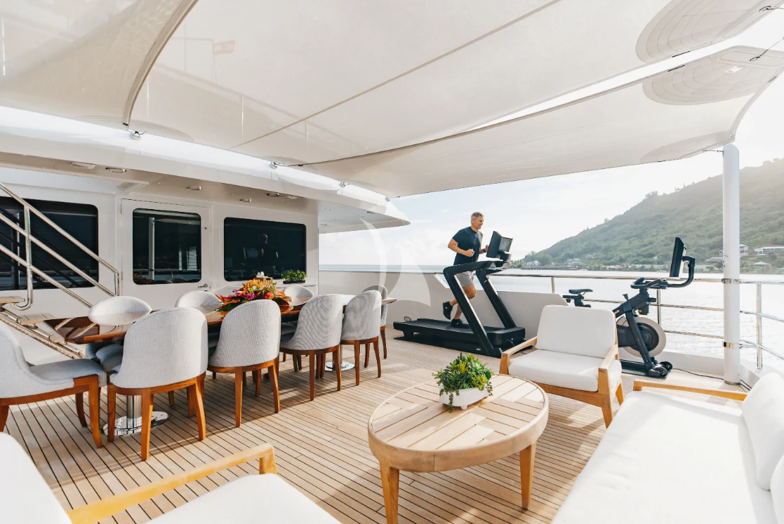 a person standing on a balcony aboard LIMITED RISKS Yacht for Charter
