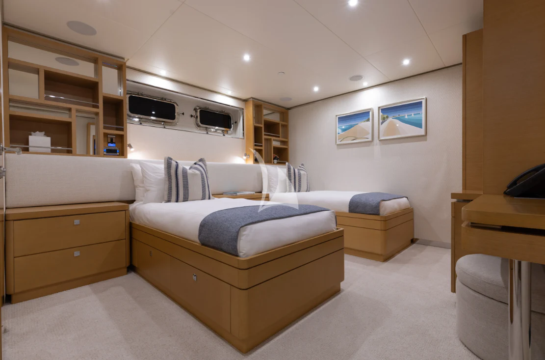 a bedroom with a bed and a tv aboard LIMITED RISKS Yacht for Charter