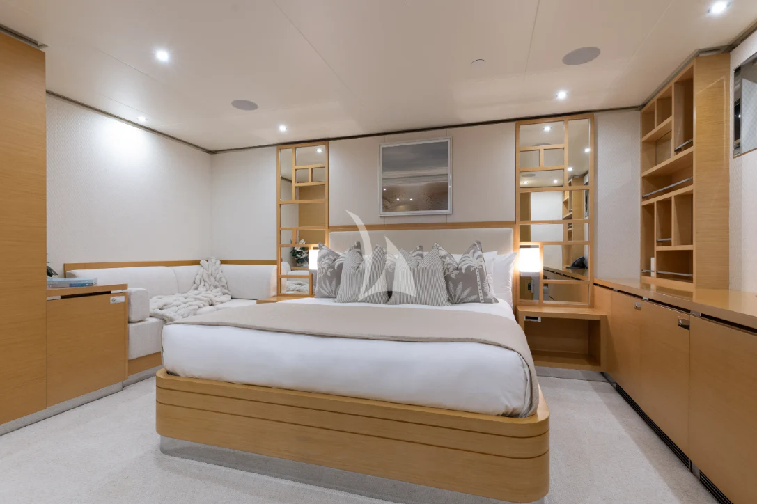 a bedroom with a bed and a bookcase aboard LIMITED RISKS Yacht for Charter