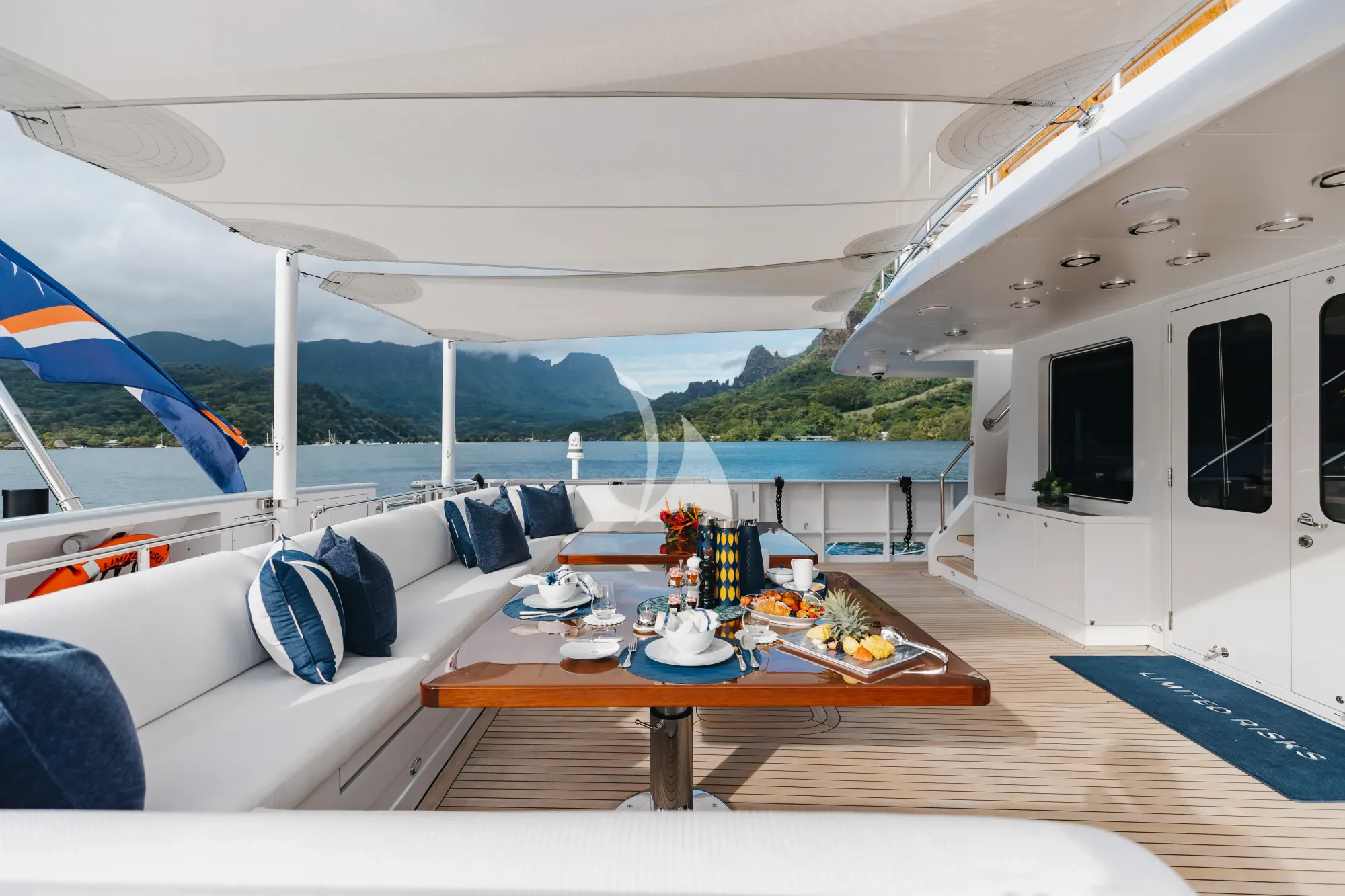a living room with a table and chairs aboard LIMITED RISKS Yacht for Charter