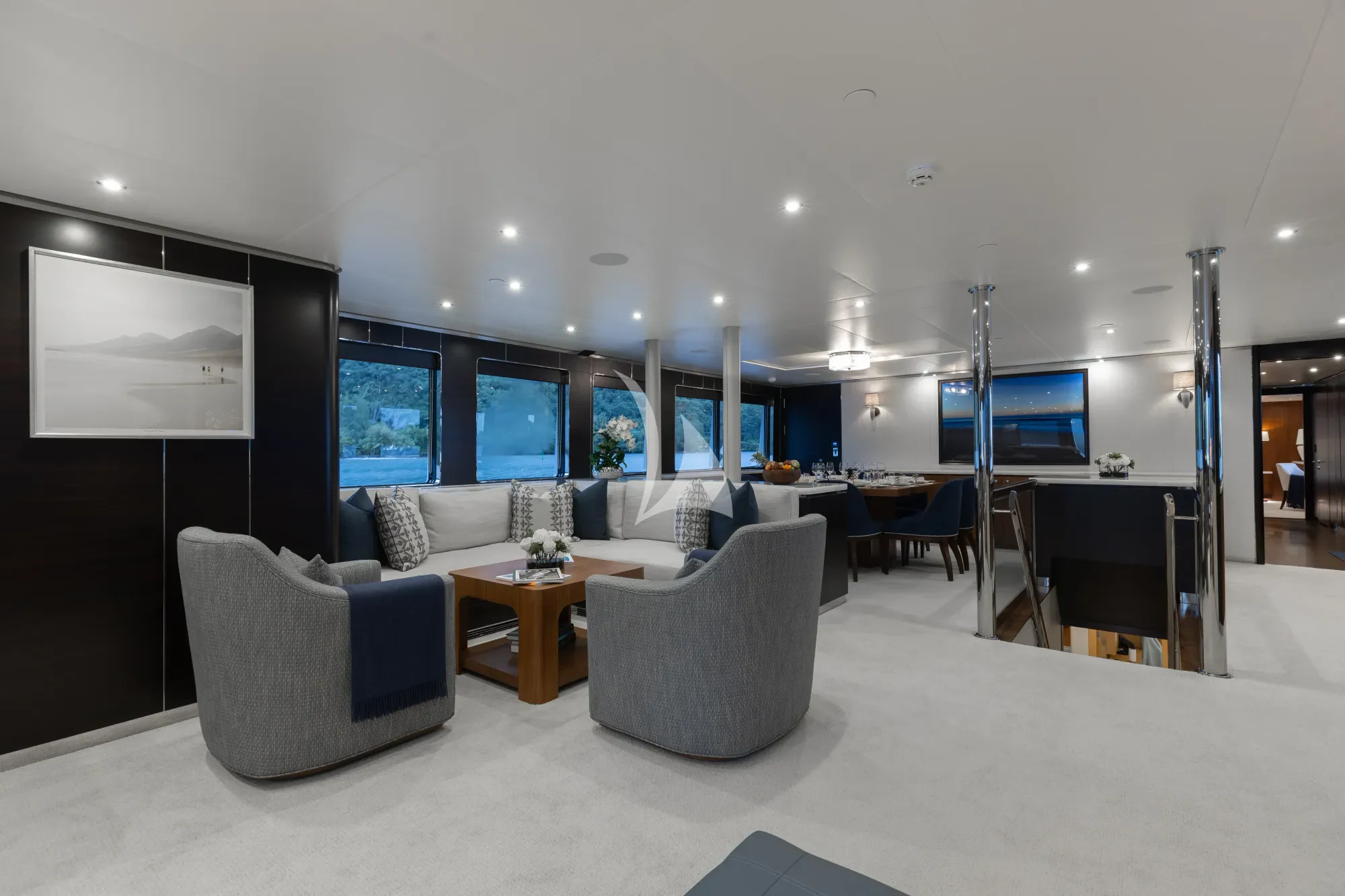 a room with a table chairs and a tv aboard LIMITED RISKS Yacht for Charter