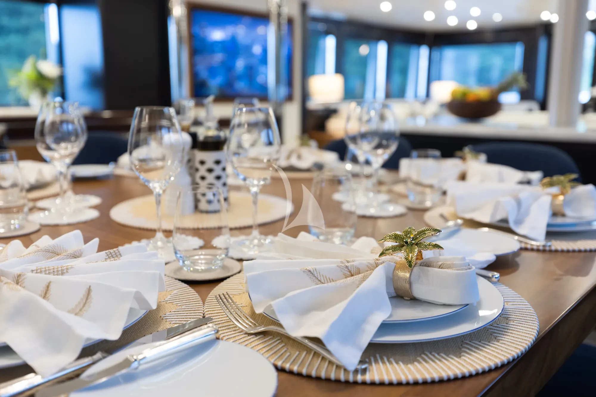 a table with plates and glasses aboard LIMITED RISKS Yacht for Charter