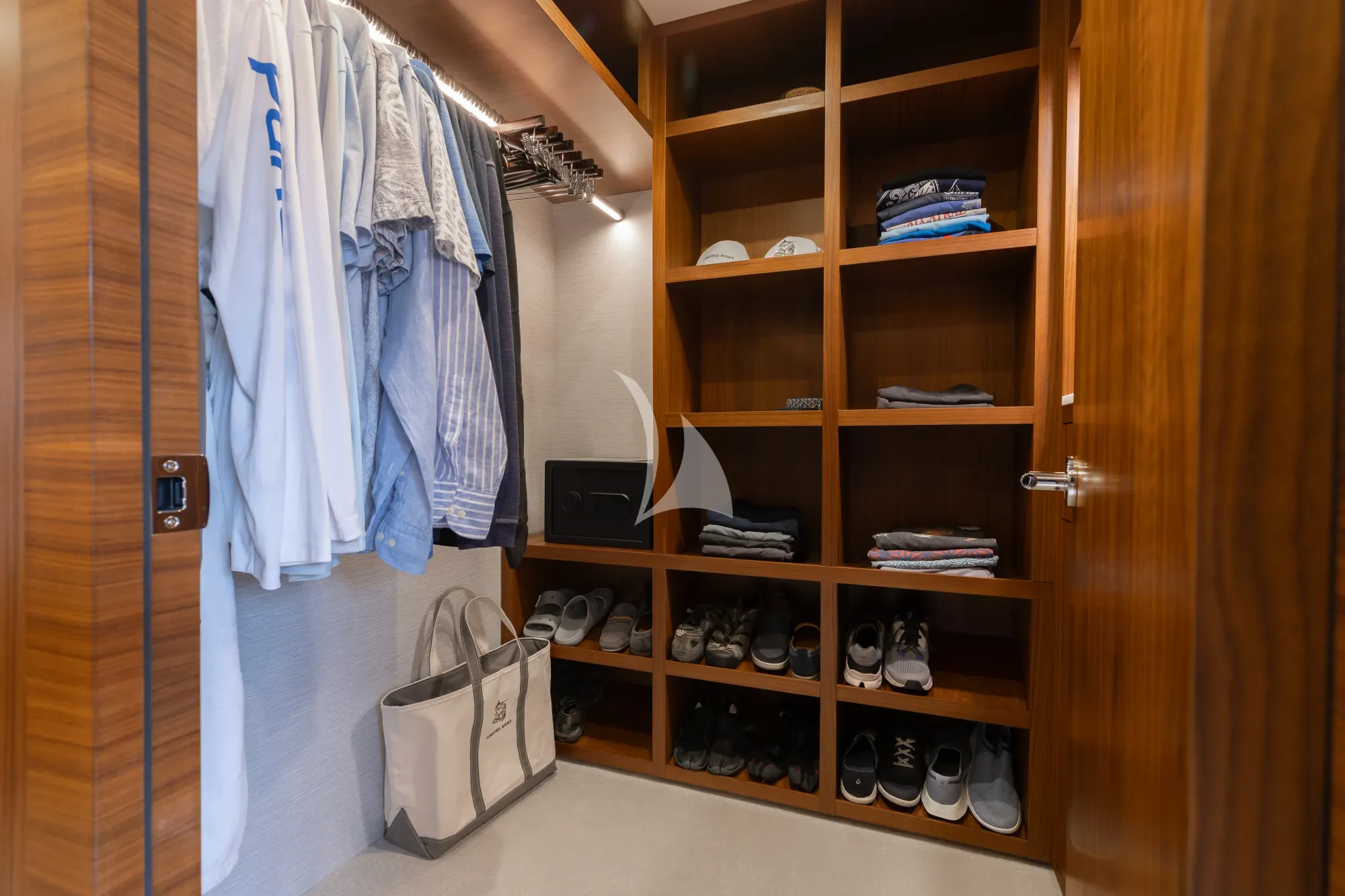 a closet full of clothes and shoes aboard LIMITED RISKS Yacht for Charter