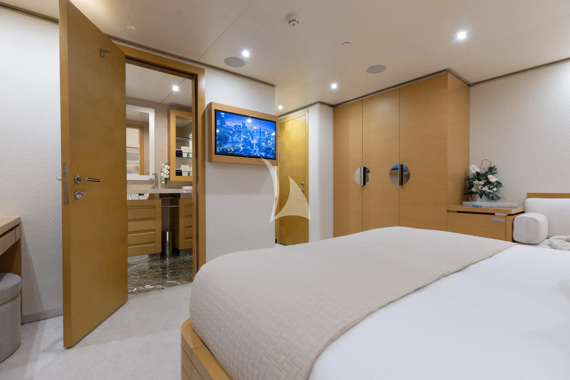 a hotel room with a bed and tv aboard LIMITED RISKS Yacht for Charter