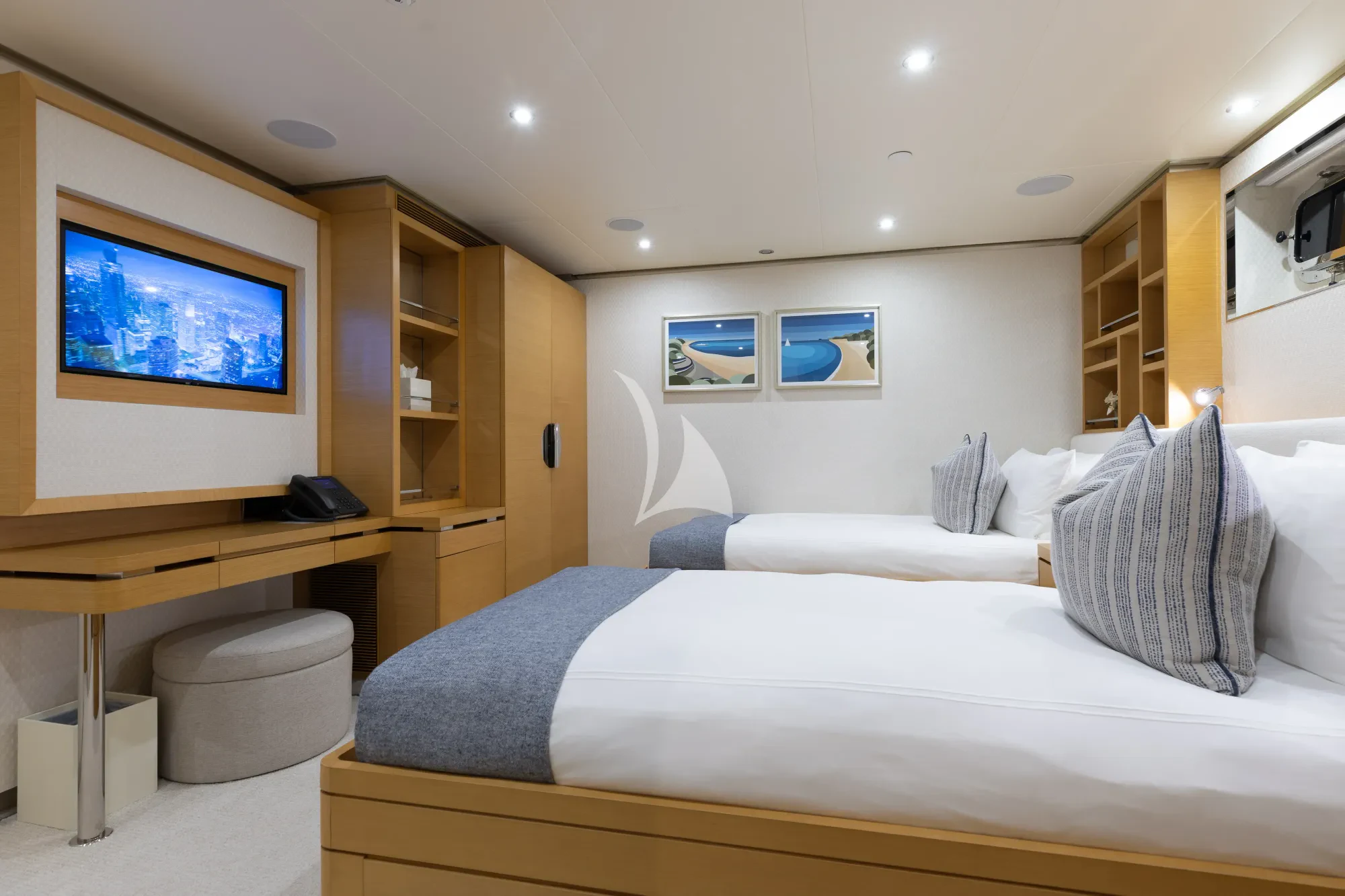 a bedroom with a bed and a desk aboard LIMITED RISKS Yacht for Charter