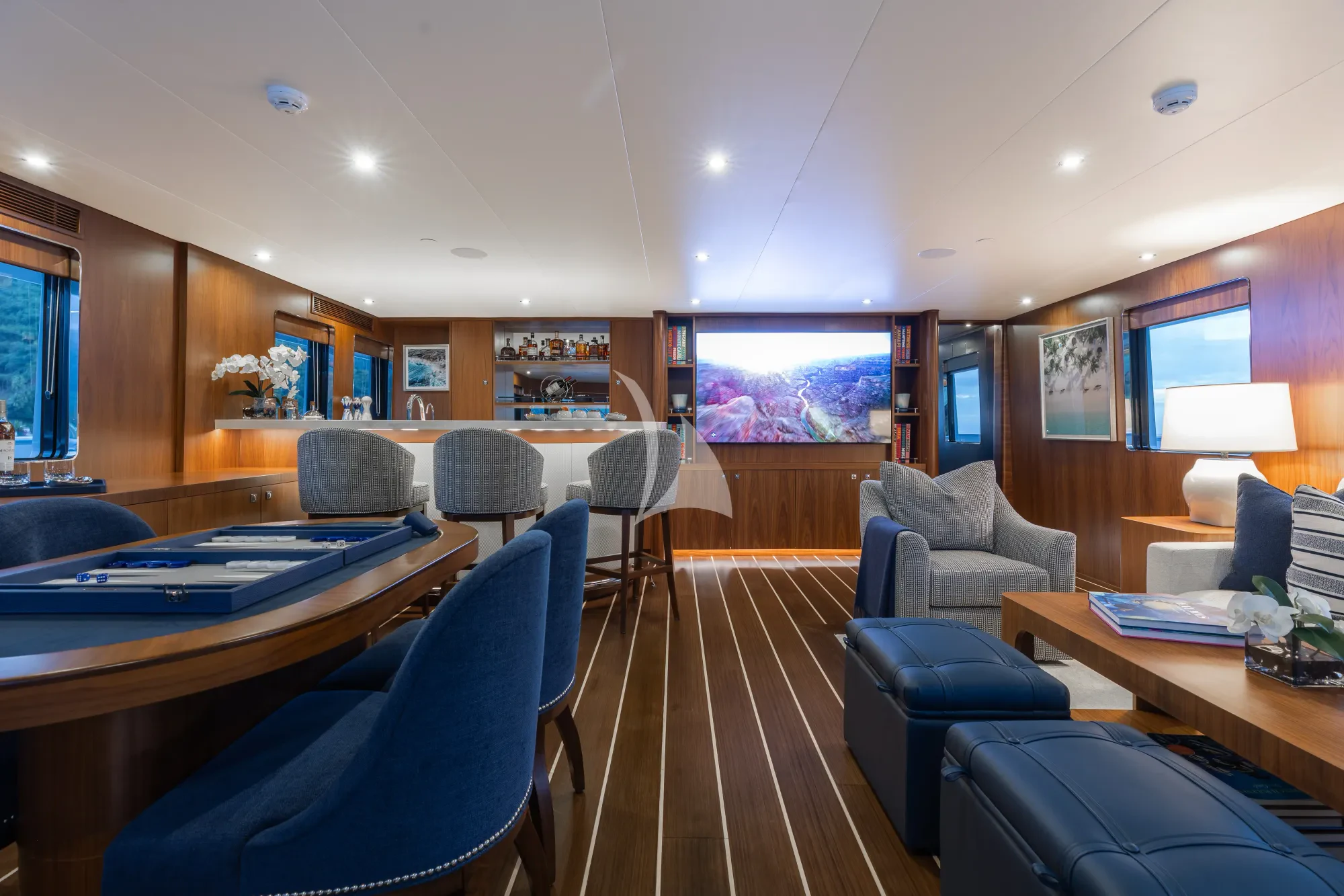 a room with a table chairs and a pool table aboard LIMITED RISKS Yacht for Charter