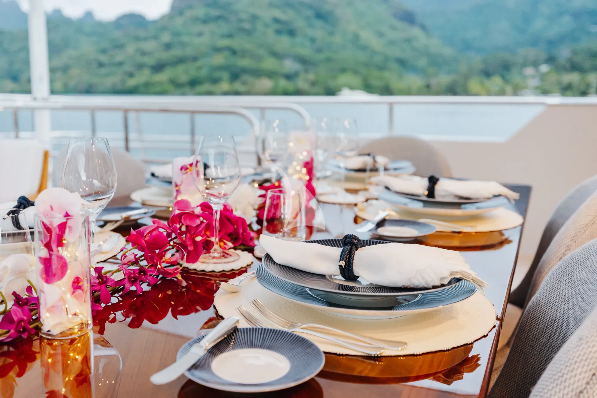 a table set with plates and glasses aboard LIMITED RISKS Yacht for Charter