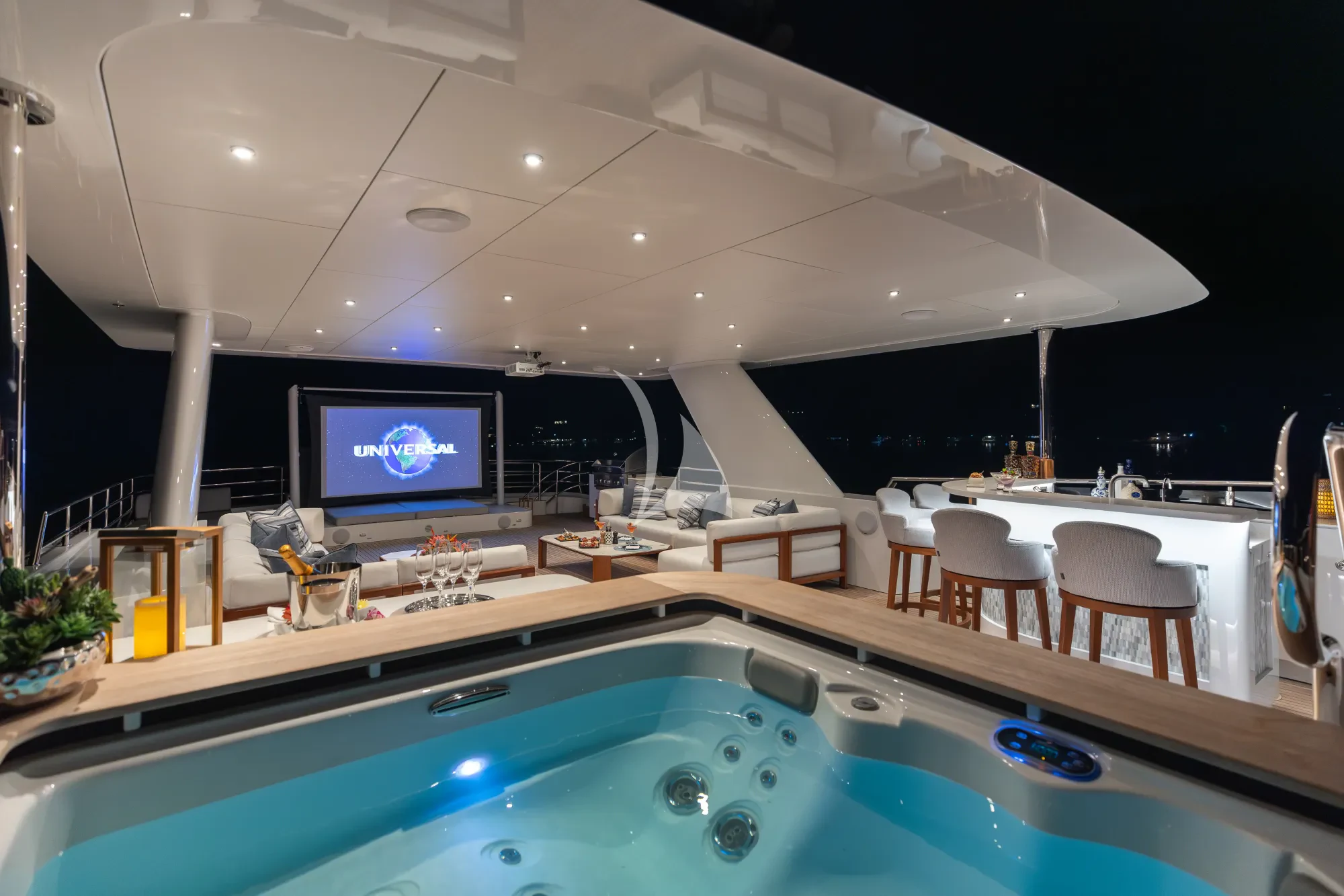 a large room with a pool table and chairs and a tv aboard LIMITED RISKS Yacht for Charter