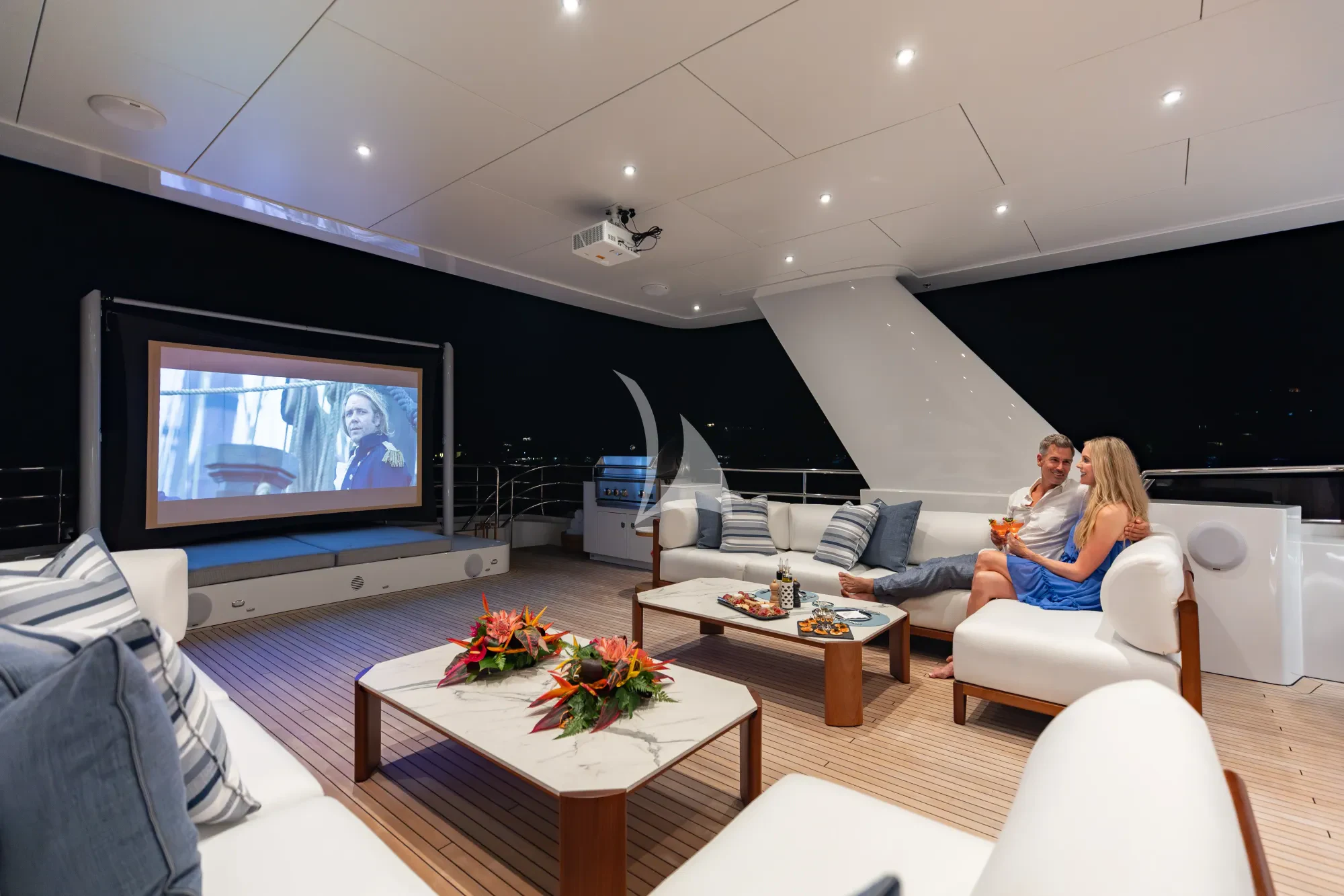 a person sitting on a couch watching television aboard LIMITED RISKS Yacht for Charter