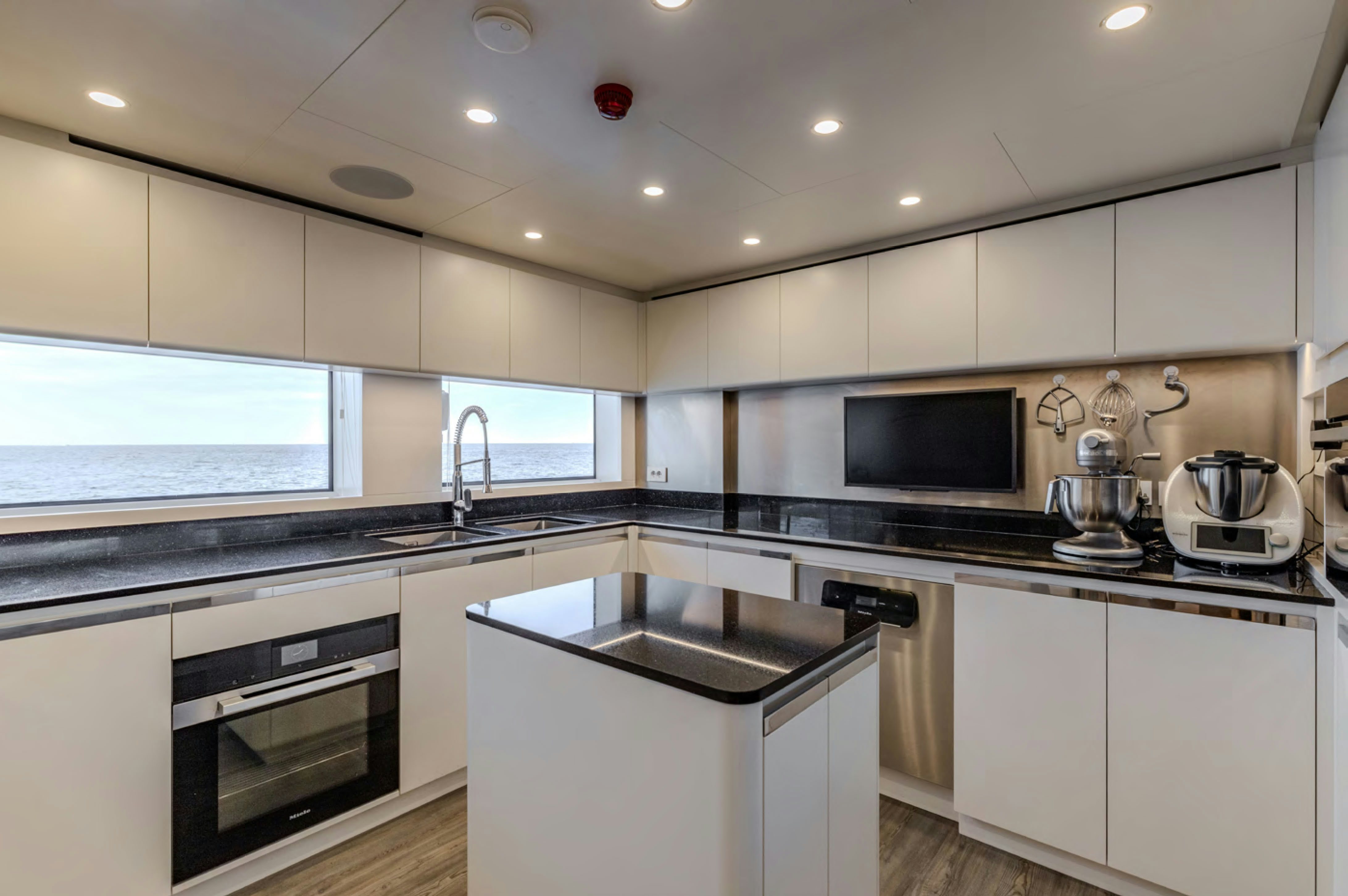 a kitchen with white cabinets aboard FELICITA Yacht for Charter