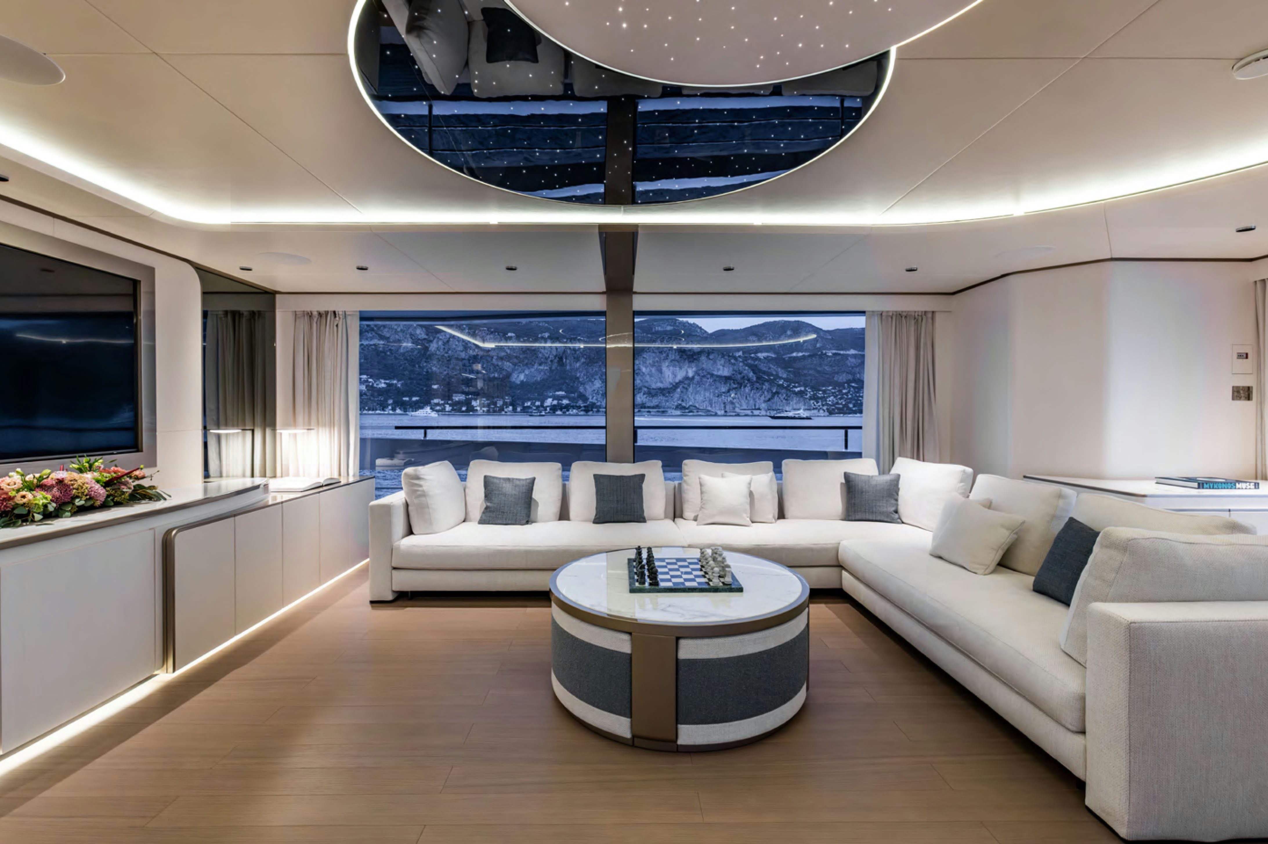 a living room with a large blue chandelier aboard FELICITA Yacht for Charter