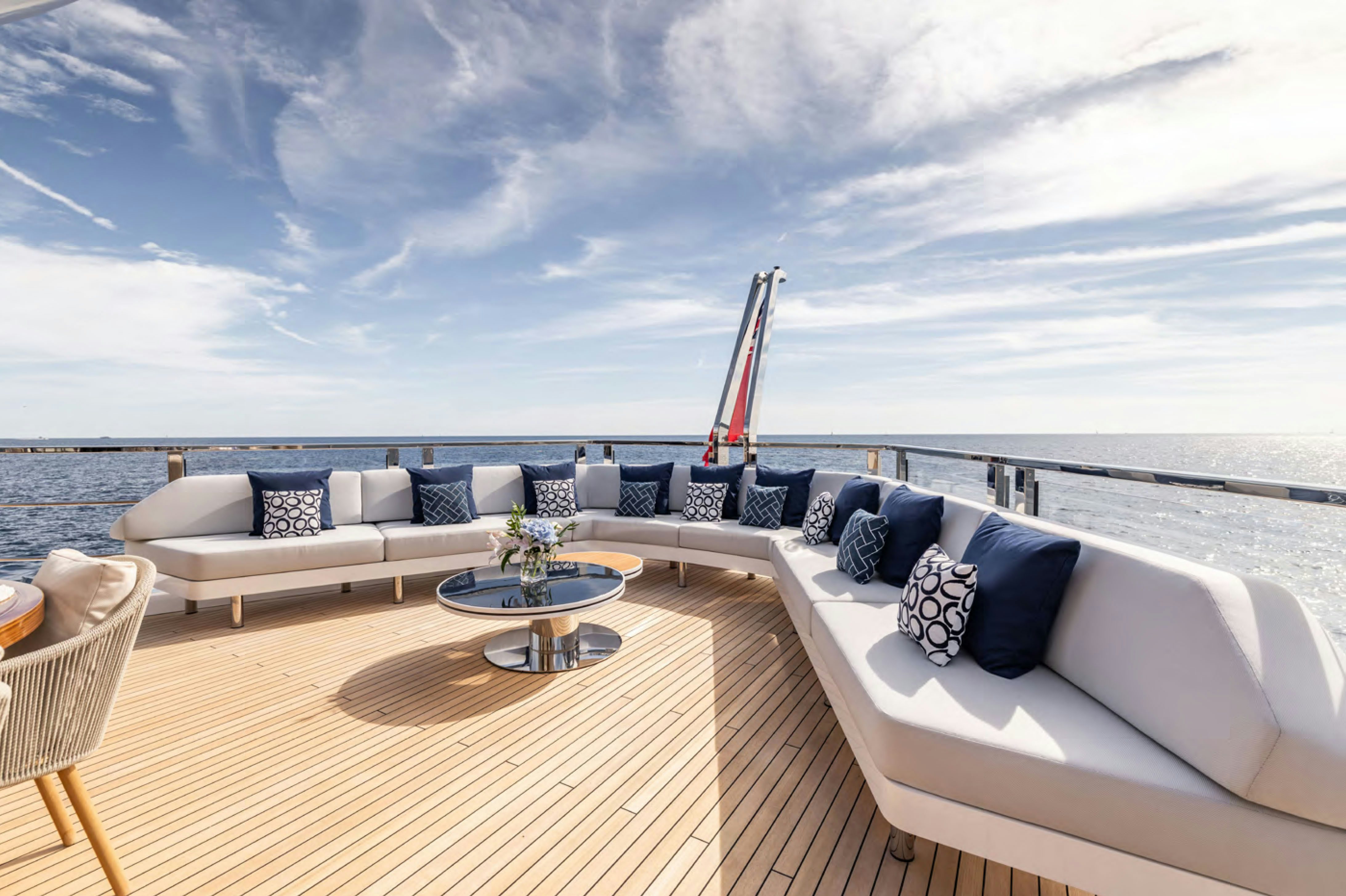 a large white lounge chair on a boardwalk with a large beach and a large blue sky aboard FELICITA Yacht for Charter