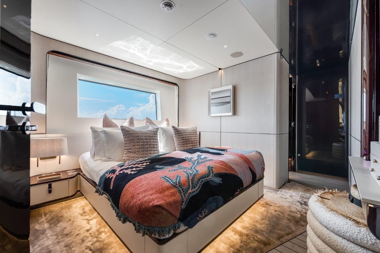 a bedroom with a bed and a tv aboard AMICO Yacht for Sale