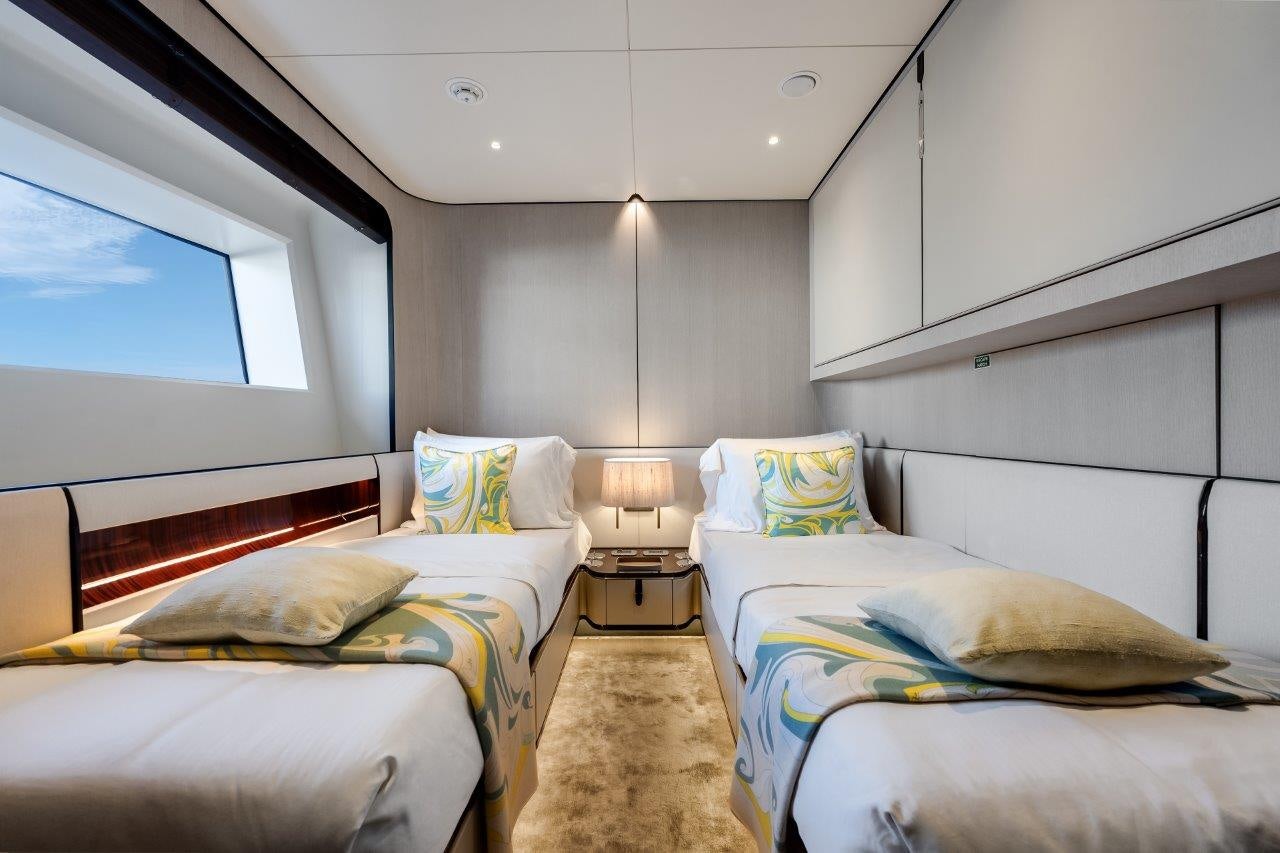 a room with two beds aboard AMICO Yacht for Sale