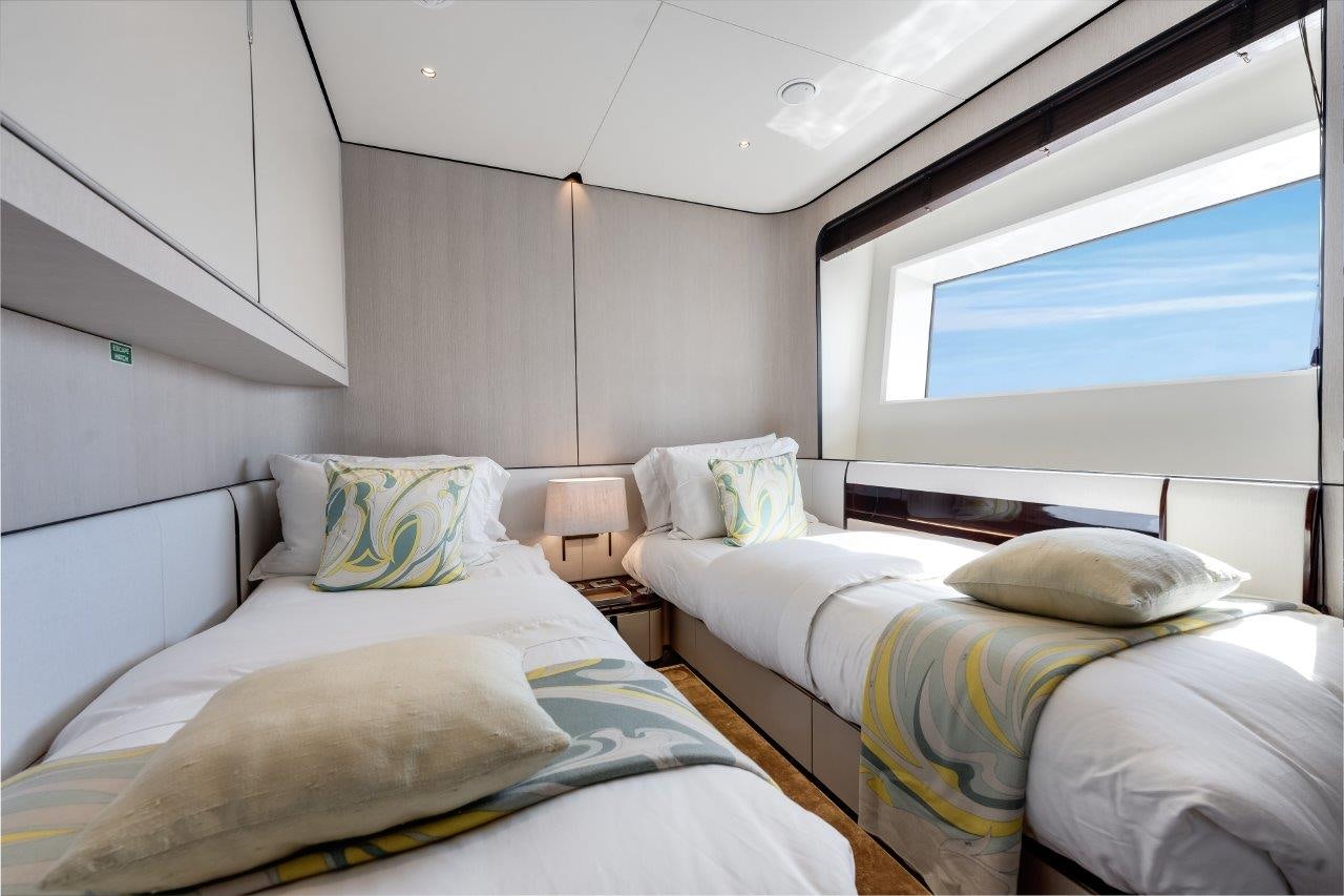 a couple of beds in a room aboard AMICO Yacht for Sale