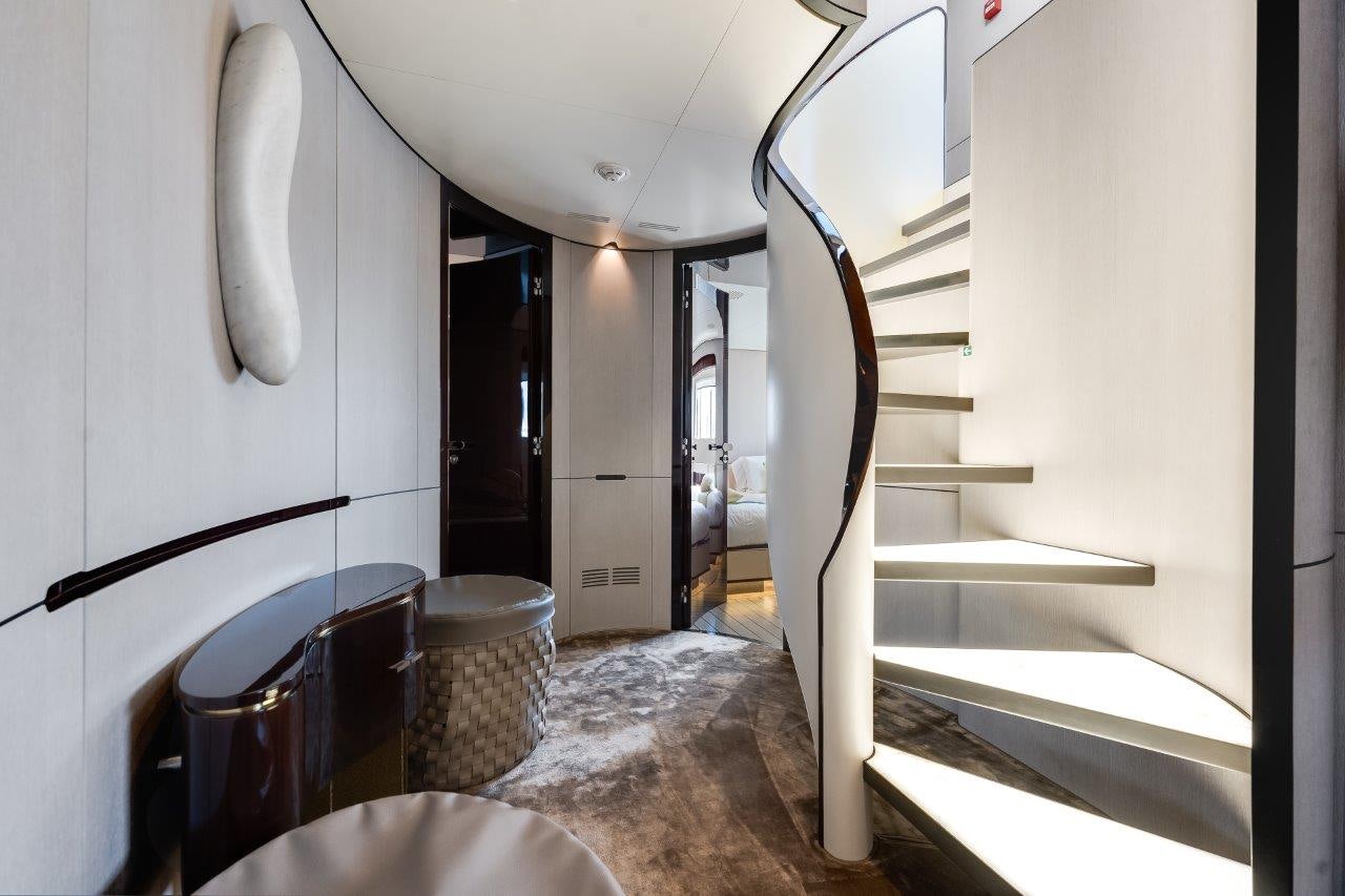 a hallway with a table and a toilet aboard AMICO Yacht for Sale