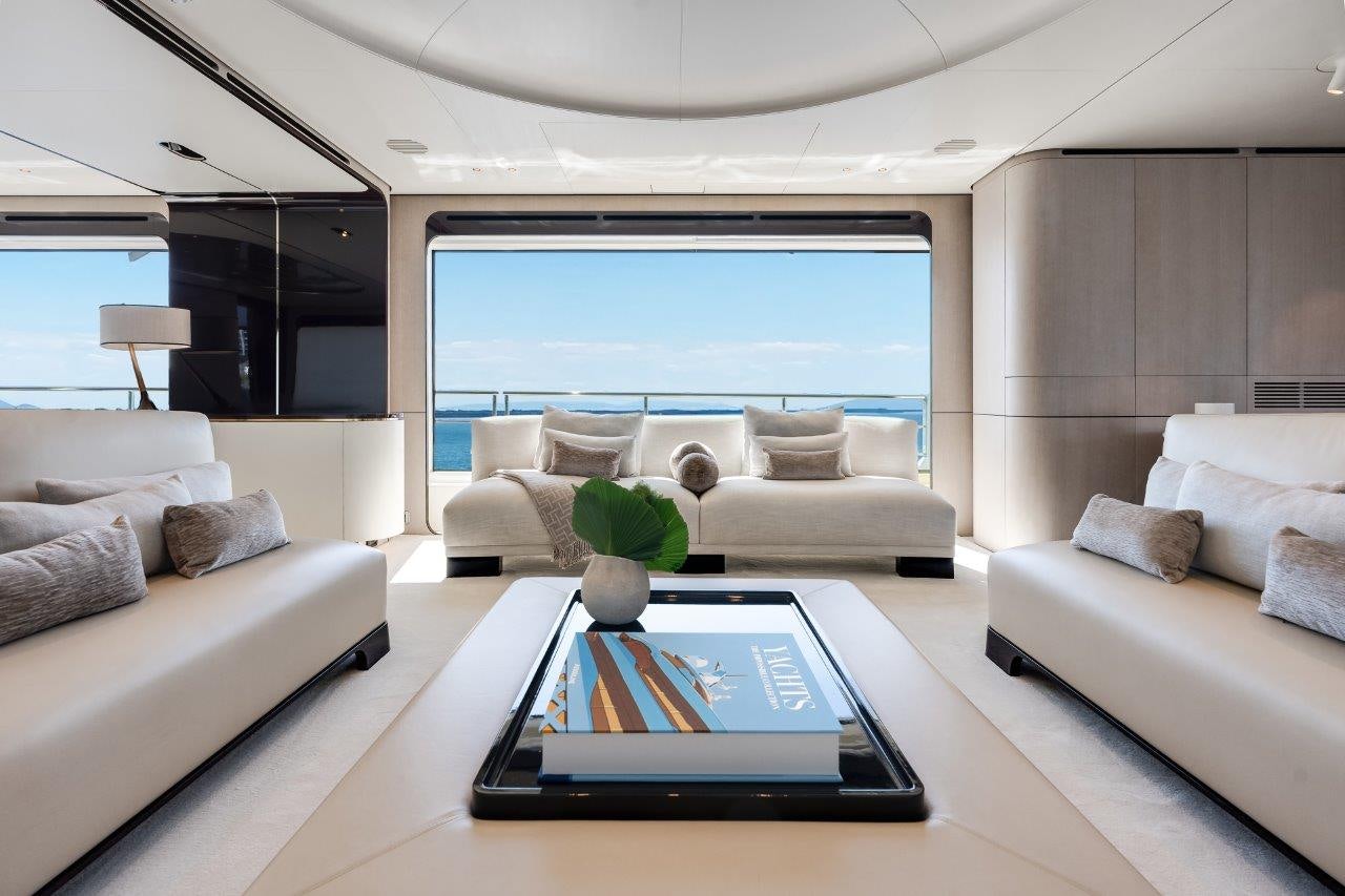 a living room with a large window aboard AMICO Yacht for Sale