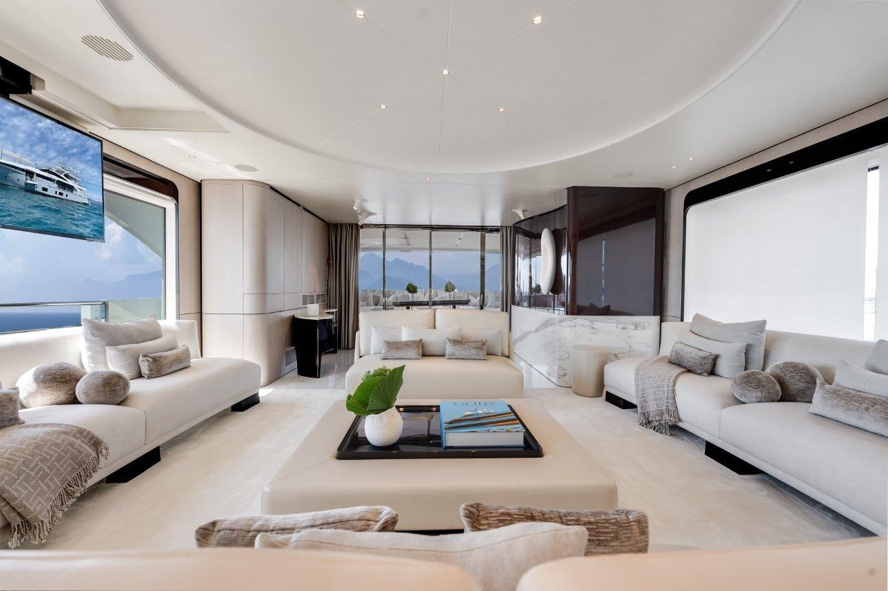 a living room with a large window aboard AMICO Yacht for Sale