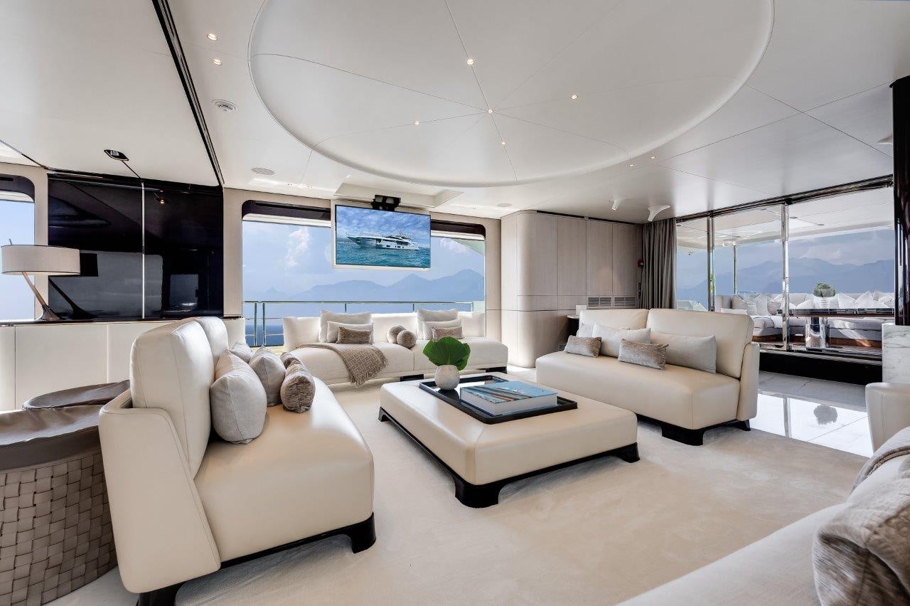 a living room with a large screen aboard AMICO Yacht for Sale