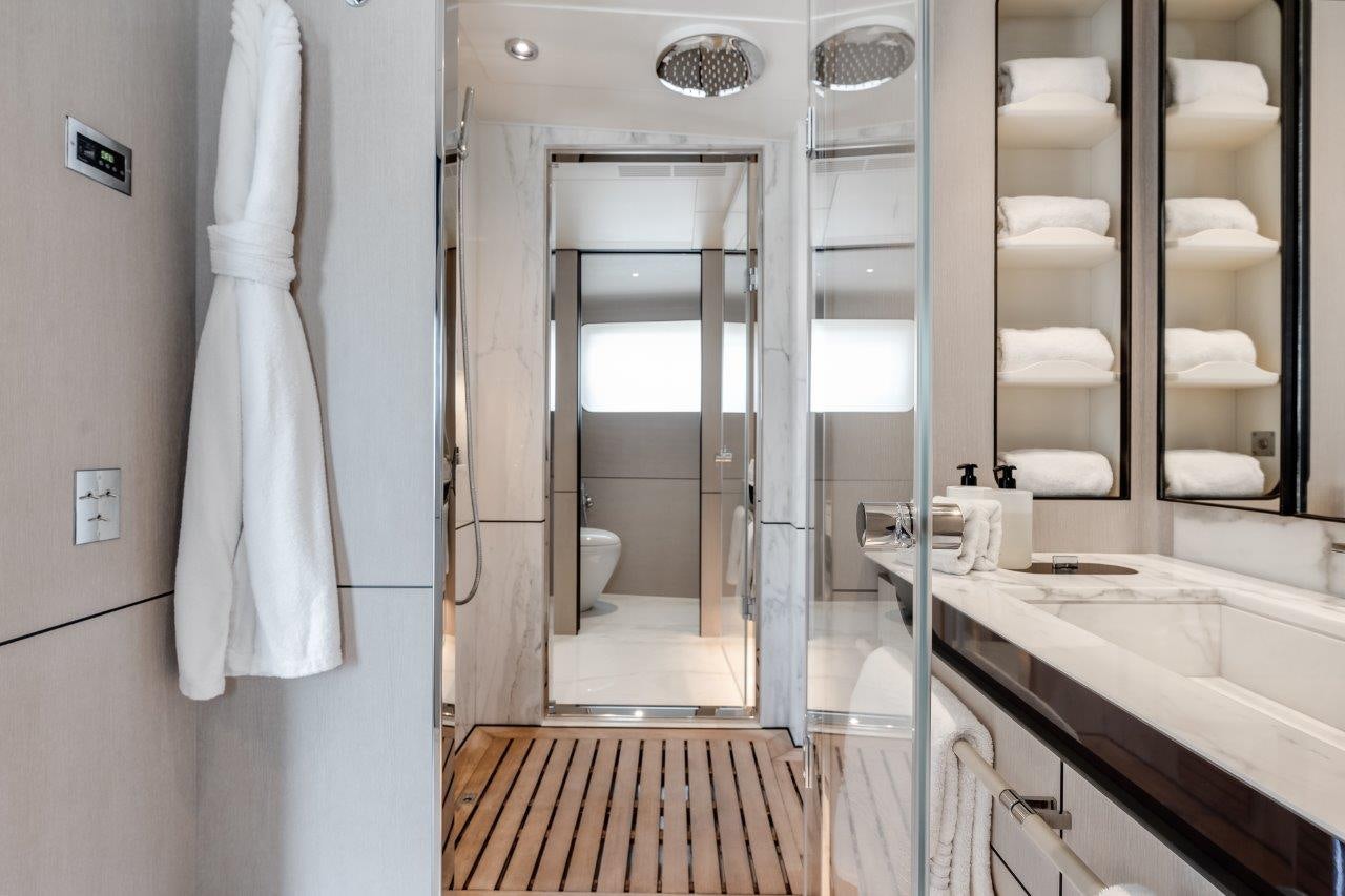 a bathroom with a glass shower aboard AMICO Yacht for Sale