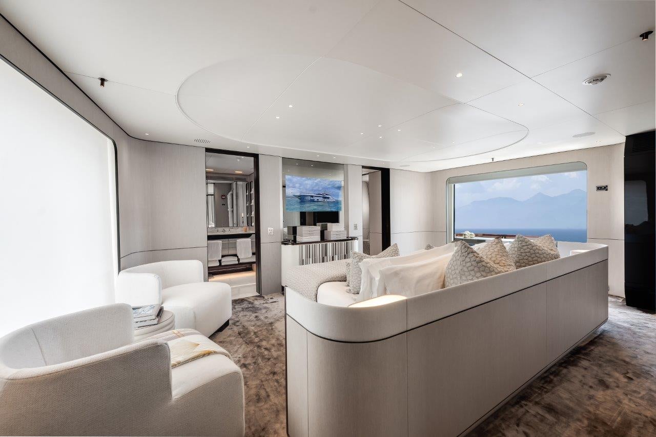 a living room with a large window aboard AMICO Yacht for Sale
