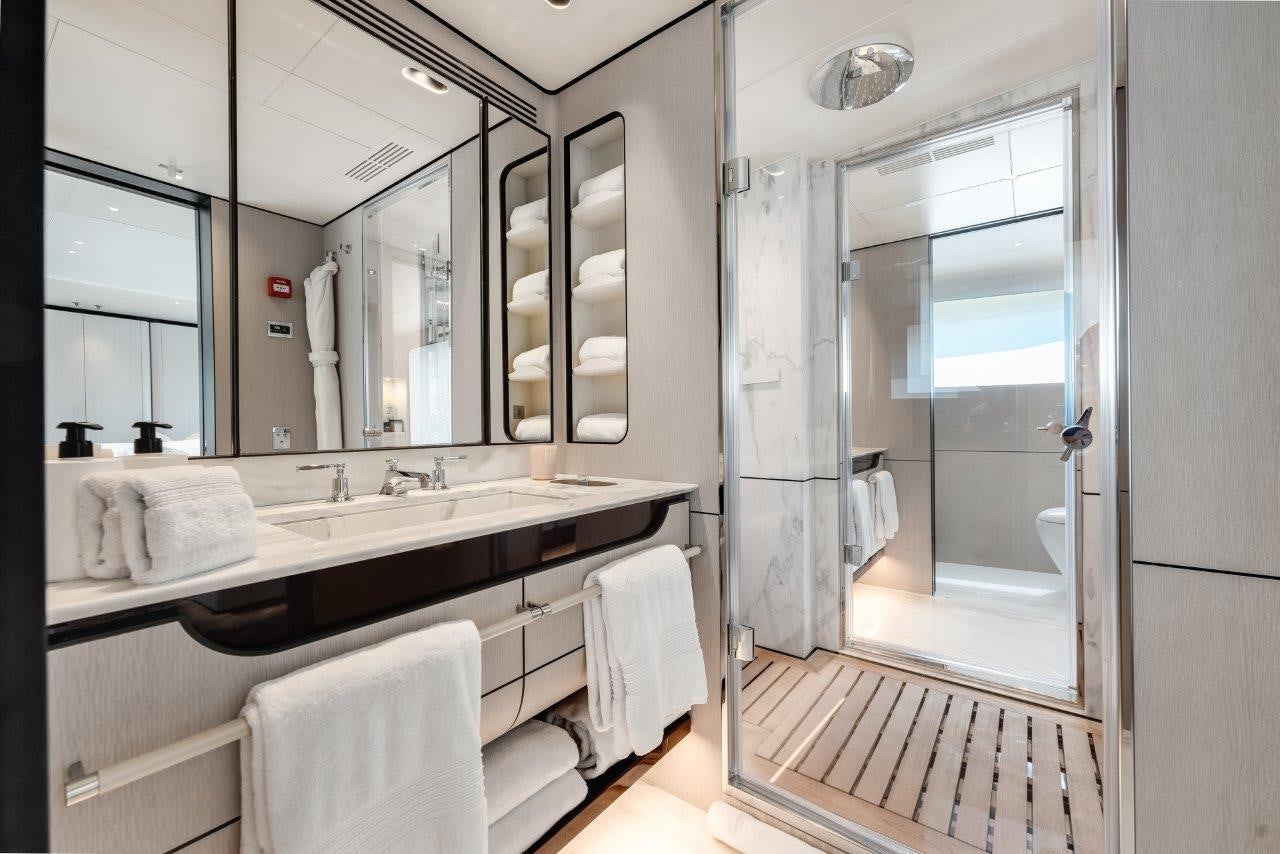 a bathroom with a large mirror aboard AMICO Yacht for Sale