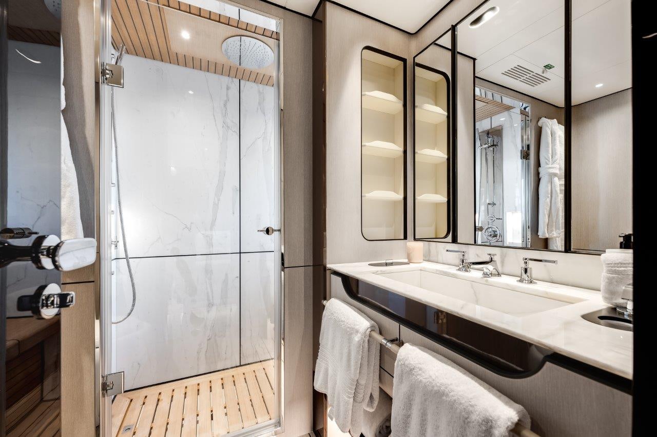 a bathroom with a large mirror aboard AMICO Yacht for Sale