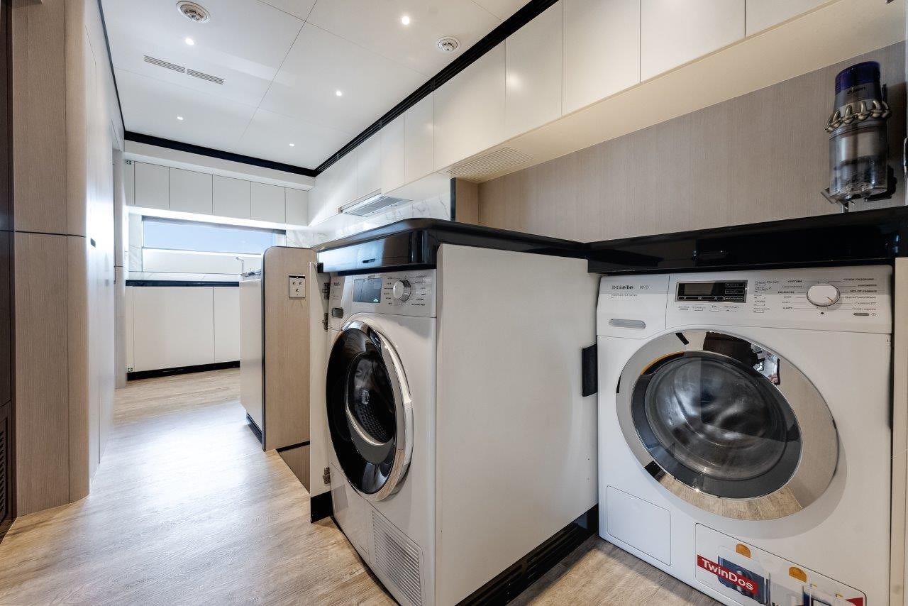 a laundry room with a washing machine aboard AMICO Yacht for Sale