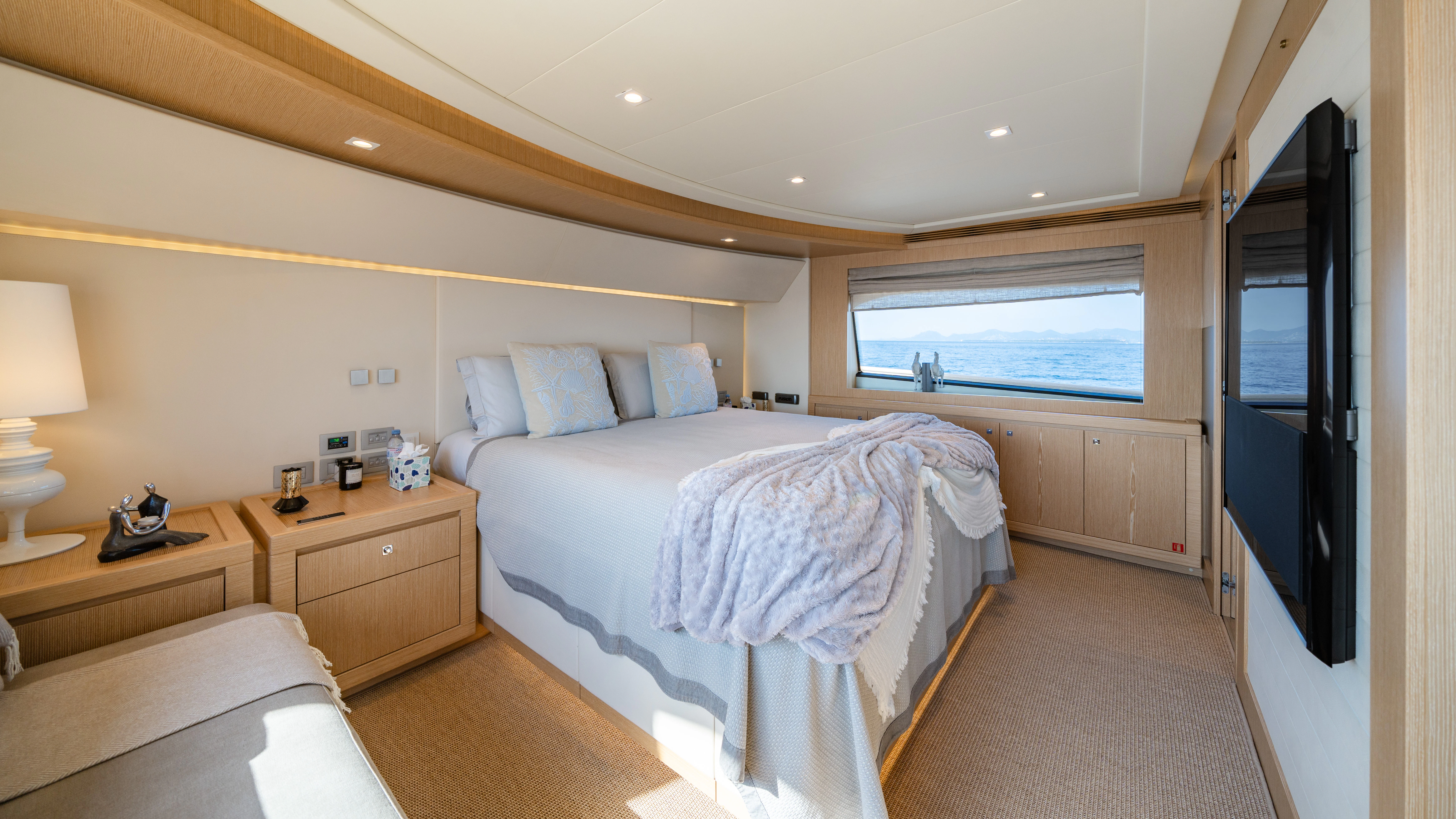 a bedroom with a bed and a desk aboard GIADA Yacht for Sale