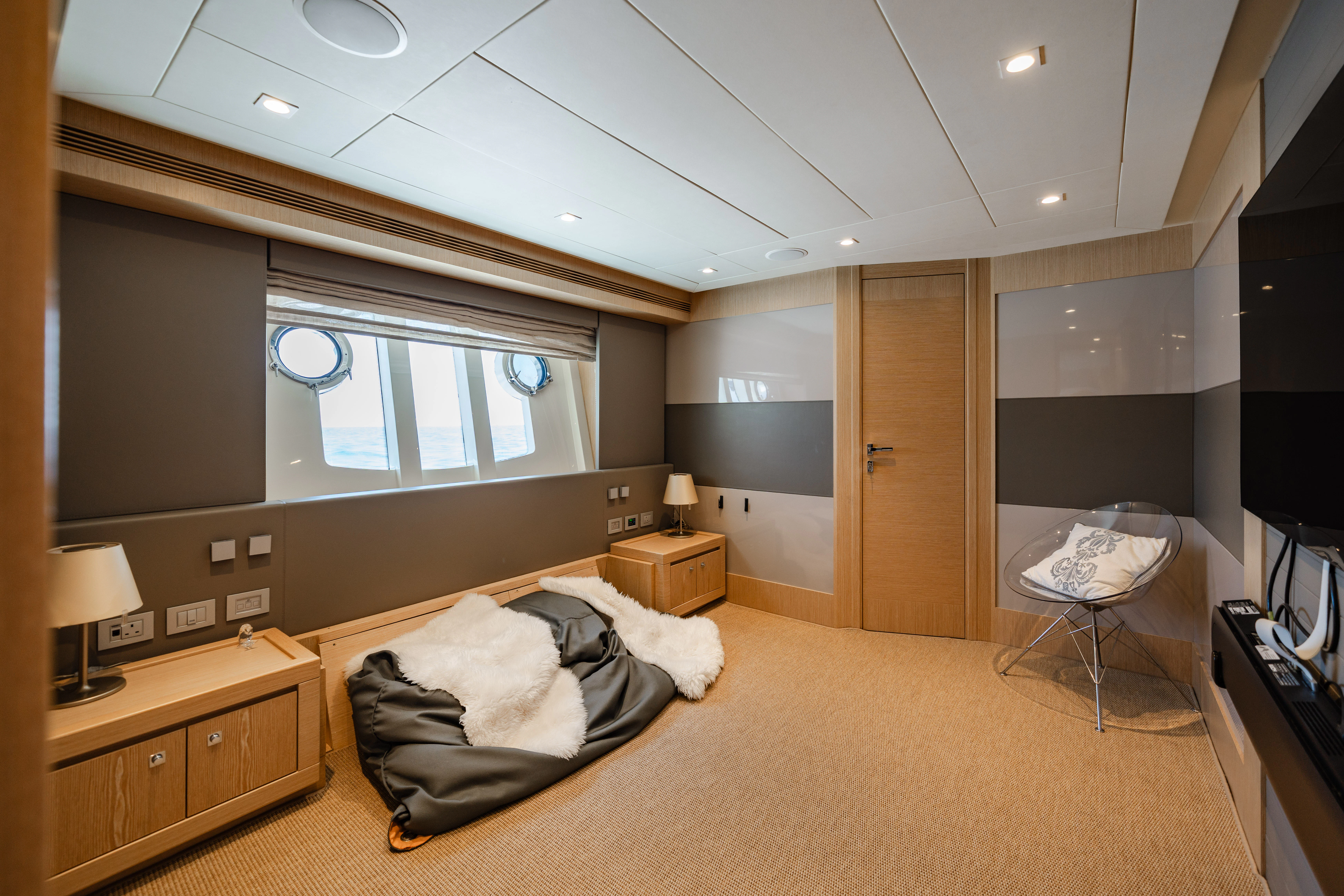 a bedroom with a bed and desk aboard GIADA Yacht for Sale