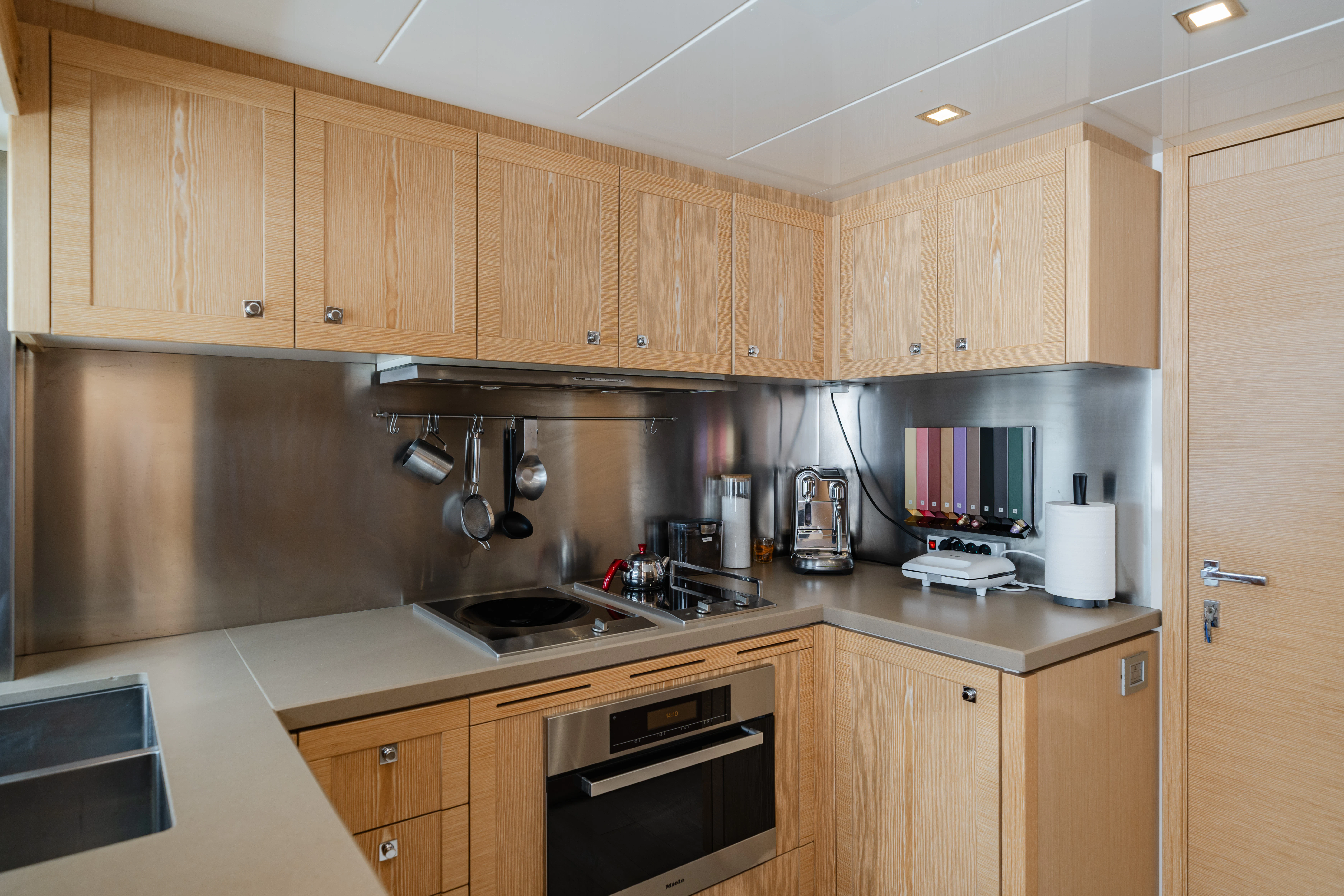 a kitchen with wooden cabinets aboard GIADA Yacht for Sale