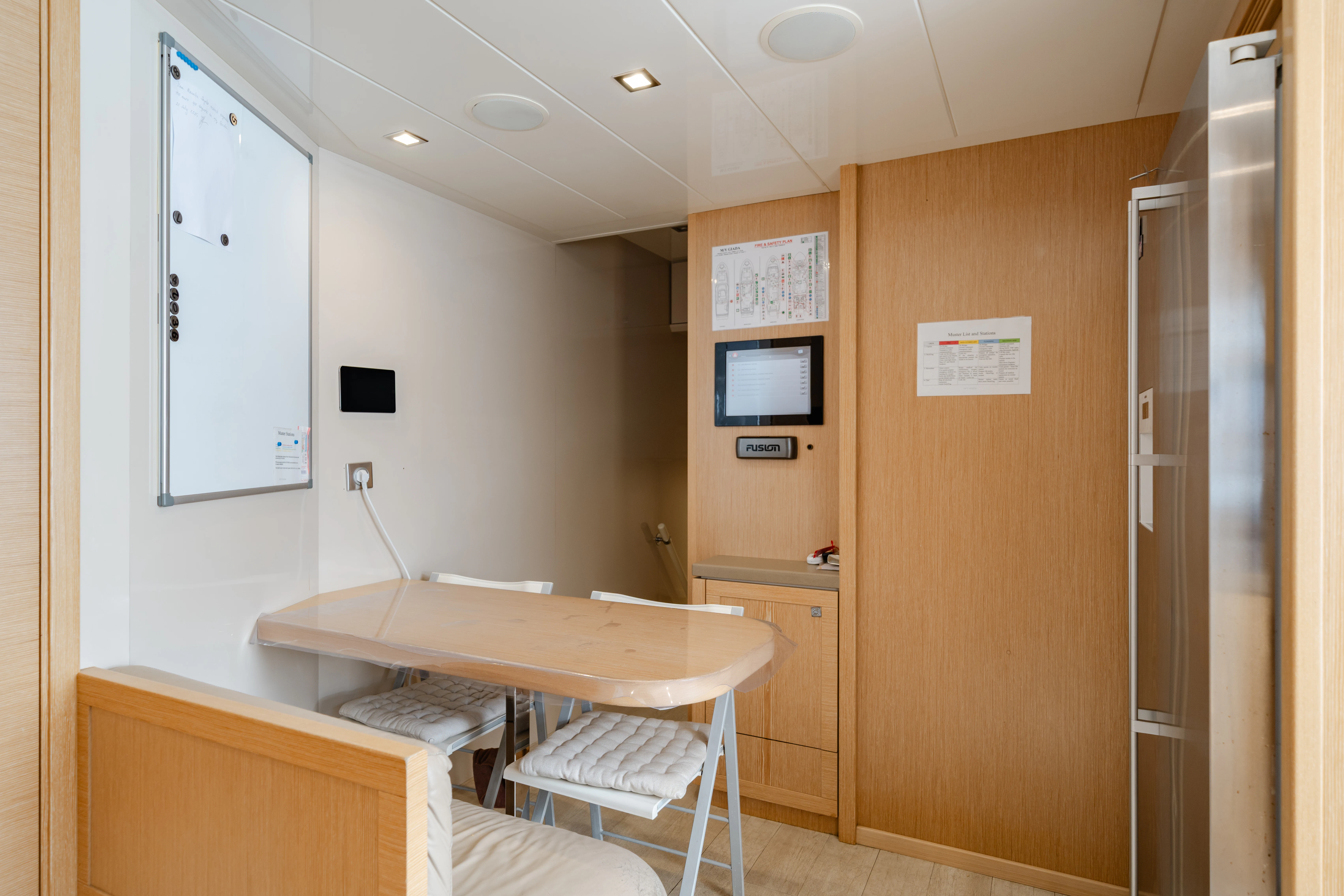 a room with a table and chairs aboard GIADA Yacht for Sale