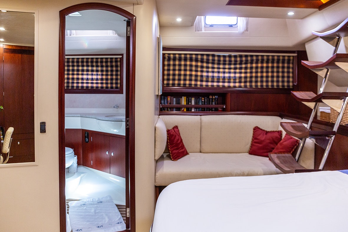 a room with a bed and a mirror aboard CYGNUS OF ANGLESEY Yacht for Sale