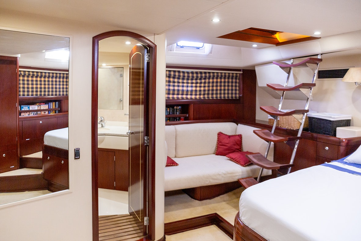 a room with a bed and a desk aboard CYGNUS OF ANGLESEY Yacht for Sale