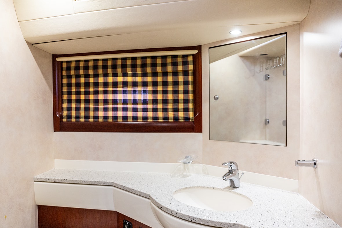 a bathroom with a mirror and a sink aboard CYGNUS OF ANGLESEY Yacht for Sale