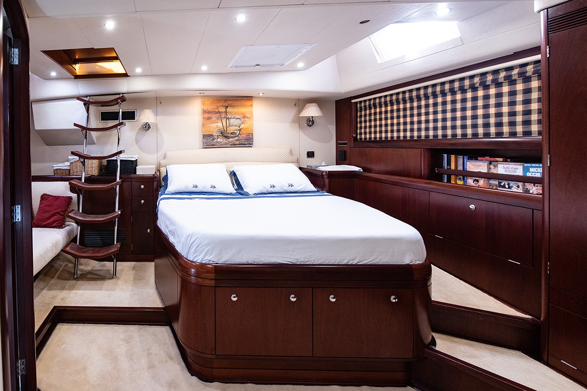 a room with a bed and a desk aboard CYGNUS OF ANGLESEY Yacht for Sale