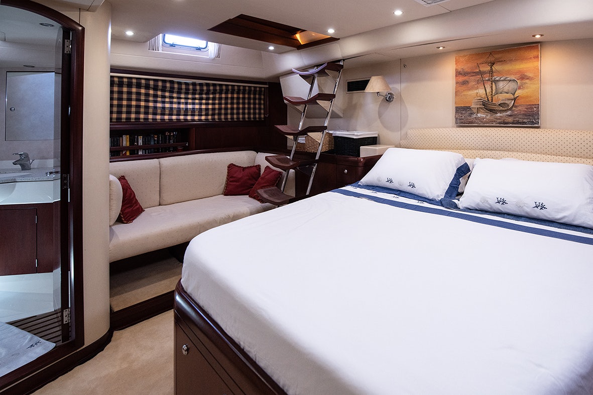 a room with a bed and a couch aboard CYGNUS OF ANGLESEY Yacht for Sale