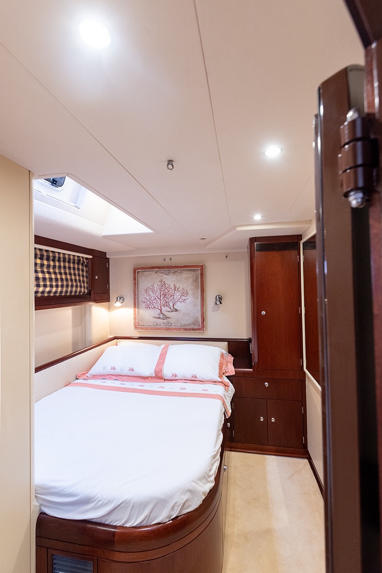 a bedroom with a bed and a closet aboard CYGNUS OF ANGLESEY Yacht for Sale